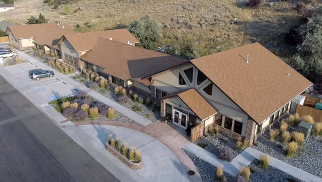 Aerial view of Cody Regional Health Spirit Mountain Hospice House with a curved driveway and landscaping.