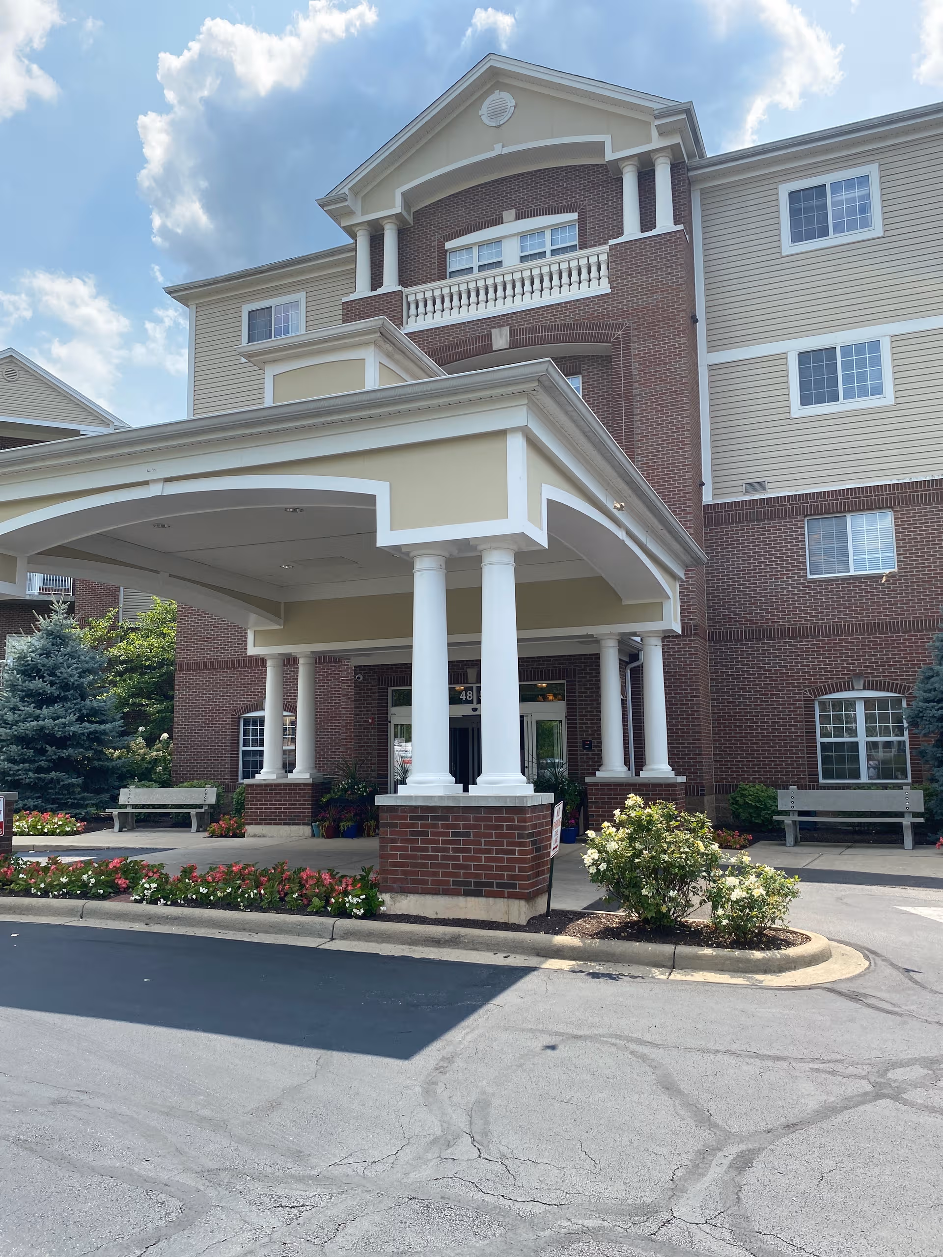 Exterior view of Barrington of Oakley featuring brick facade and a covered entrance.