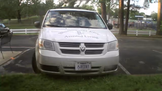 White van labeled Bluebonnet Elite Assisted Living sits in a parking lot.