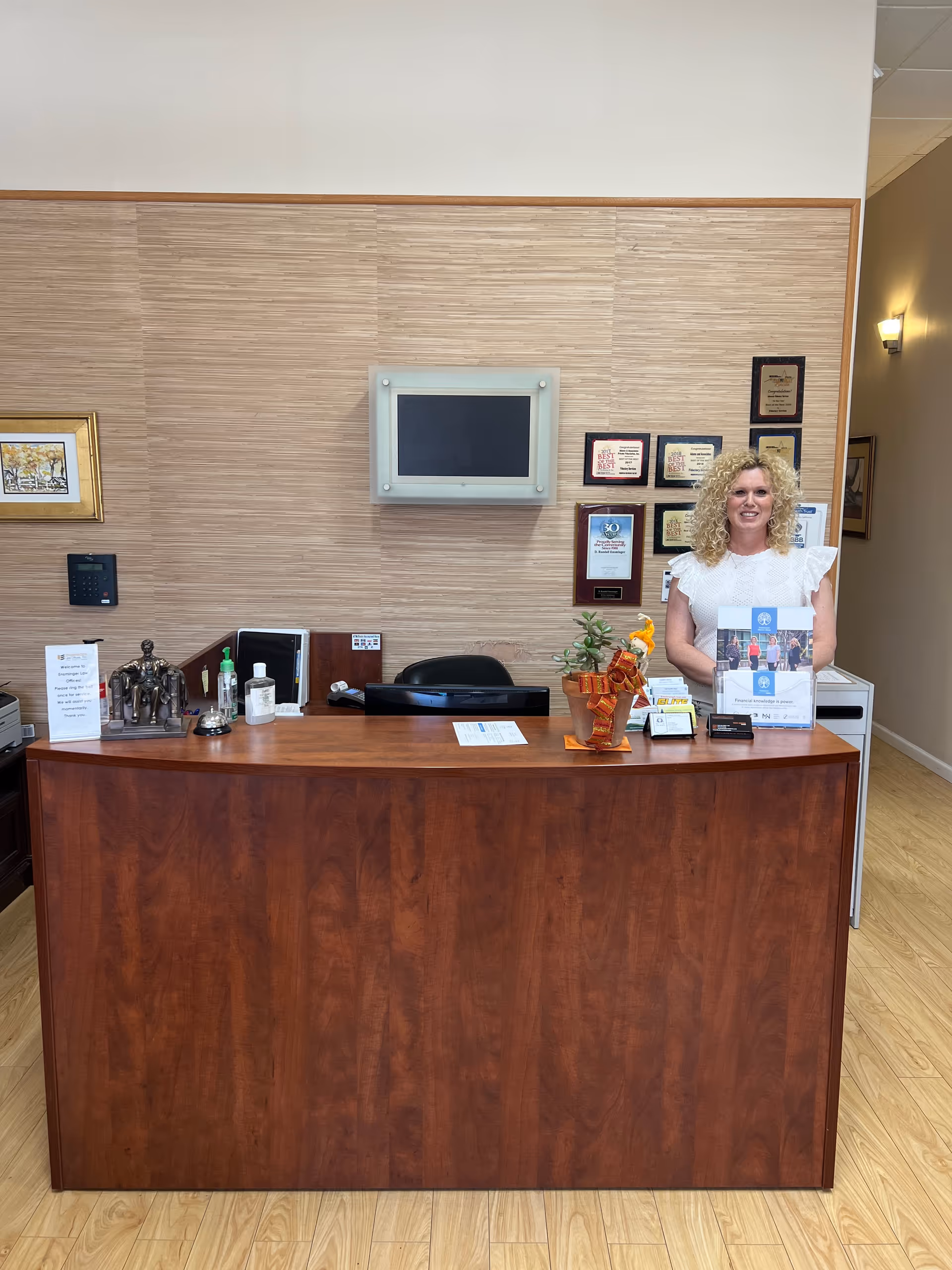 Reception desk with a smiling staff member in a senior care facility lobby.