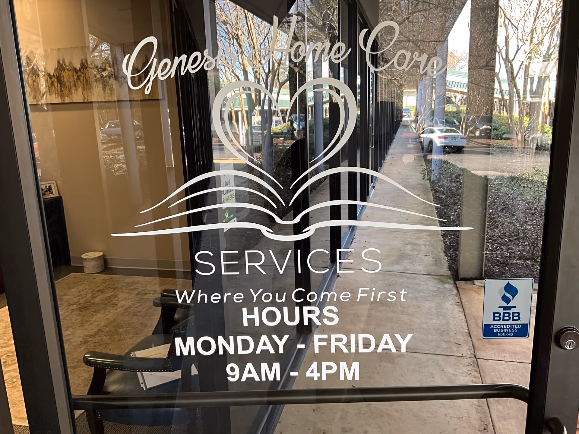 Front glass door displaying Genesis Home Care Services logo, hours, and BBB sticker.