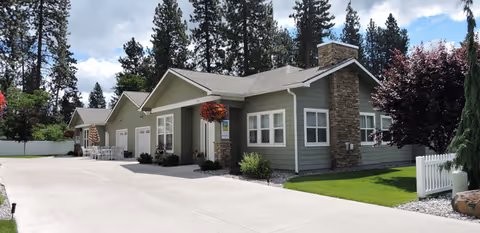 Exterior of Sunshine Adult Family Home I with driveway, entrance, and hanging flower baskets.