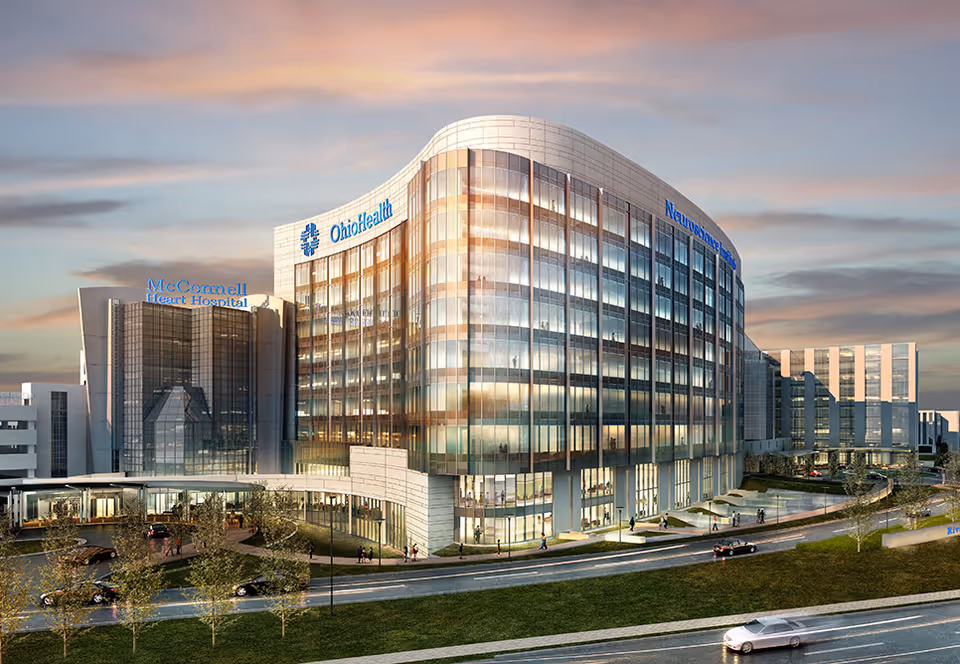 Curved glass hospital building featuring Neuroscience Center Infusion Services signage.