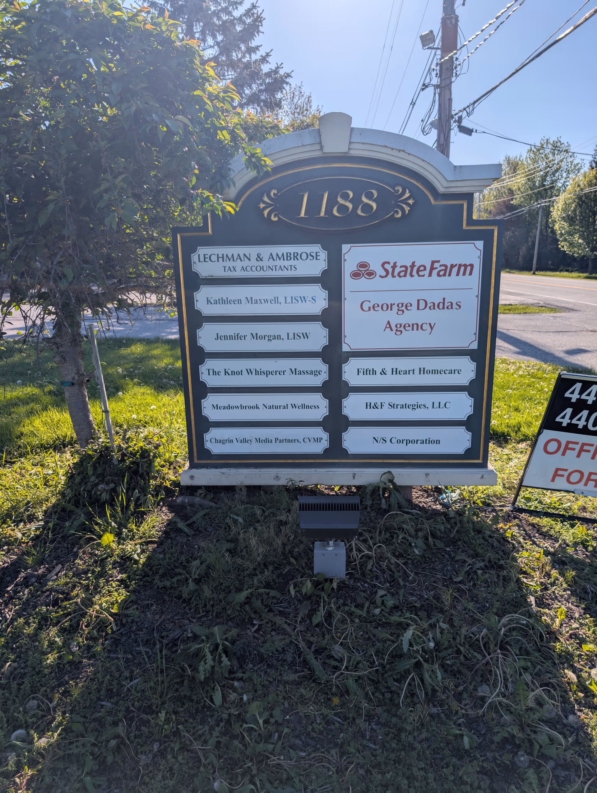 Outdoor signboard listing tenants, including Fifth & Heart Homecare and State Farm, at 1188.