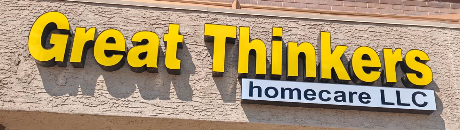 Exterior view of a building front with a large Great Thinkers sign.