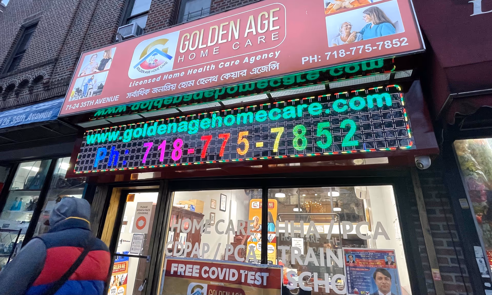 Facade of Golden Age Home Care storefront with neon sign and glass doors.