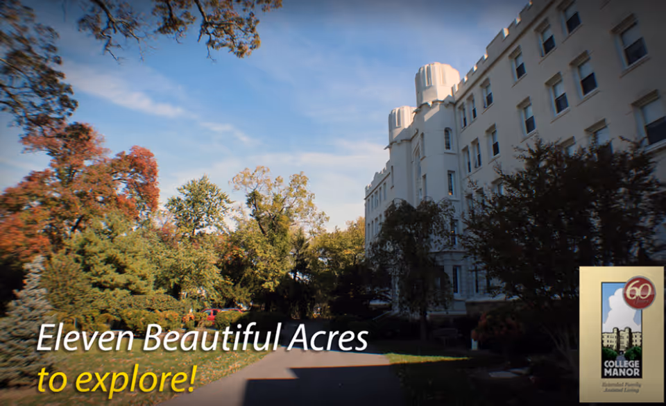 White multi-story assisted living building beside a tree-lined driveway under a blue sky with promotional text overlay.