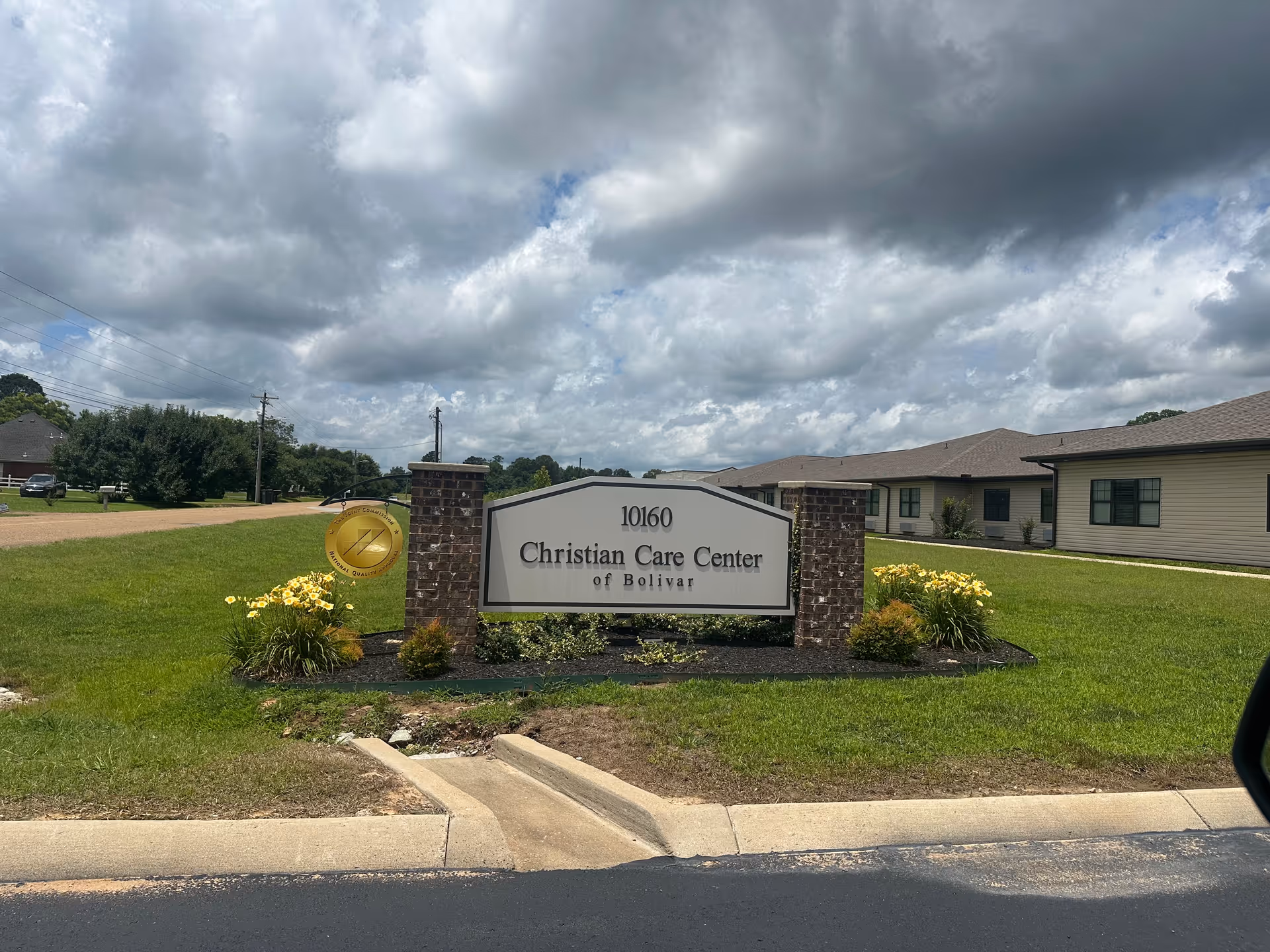 Exterior view of Christian Care Center of Bolivar with sign and manicured lawn.