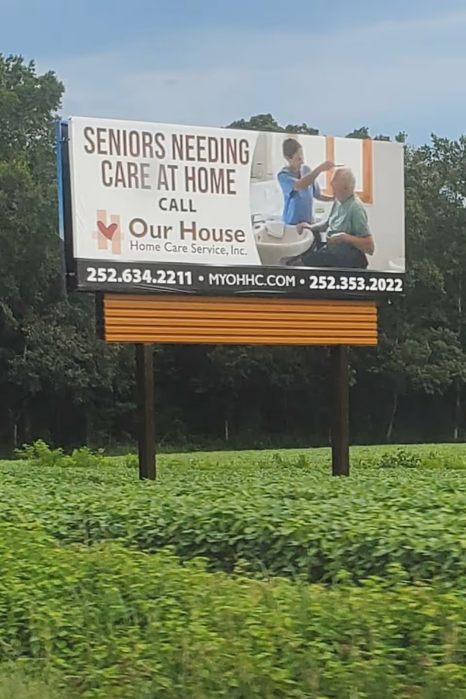 Outdoor billboard for Our House Home Care Services featuring caregiver and senior
