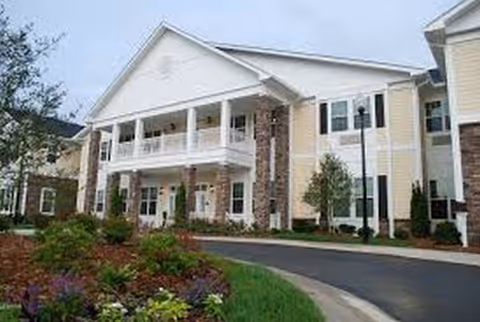 Exterior view of Cadence at Wake Forest senior living facility with a landscaped entrance