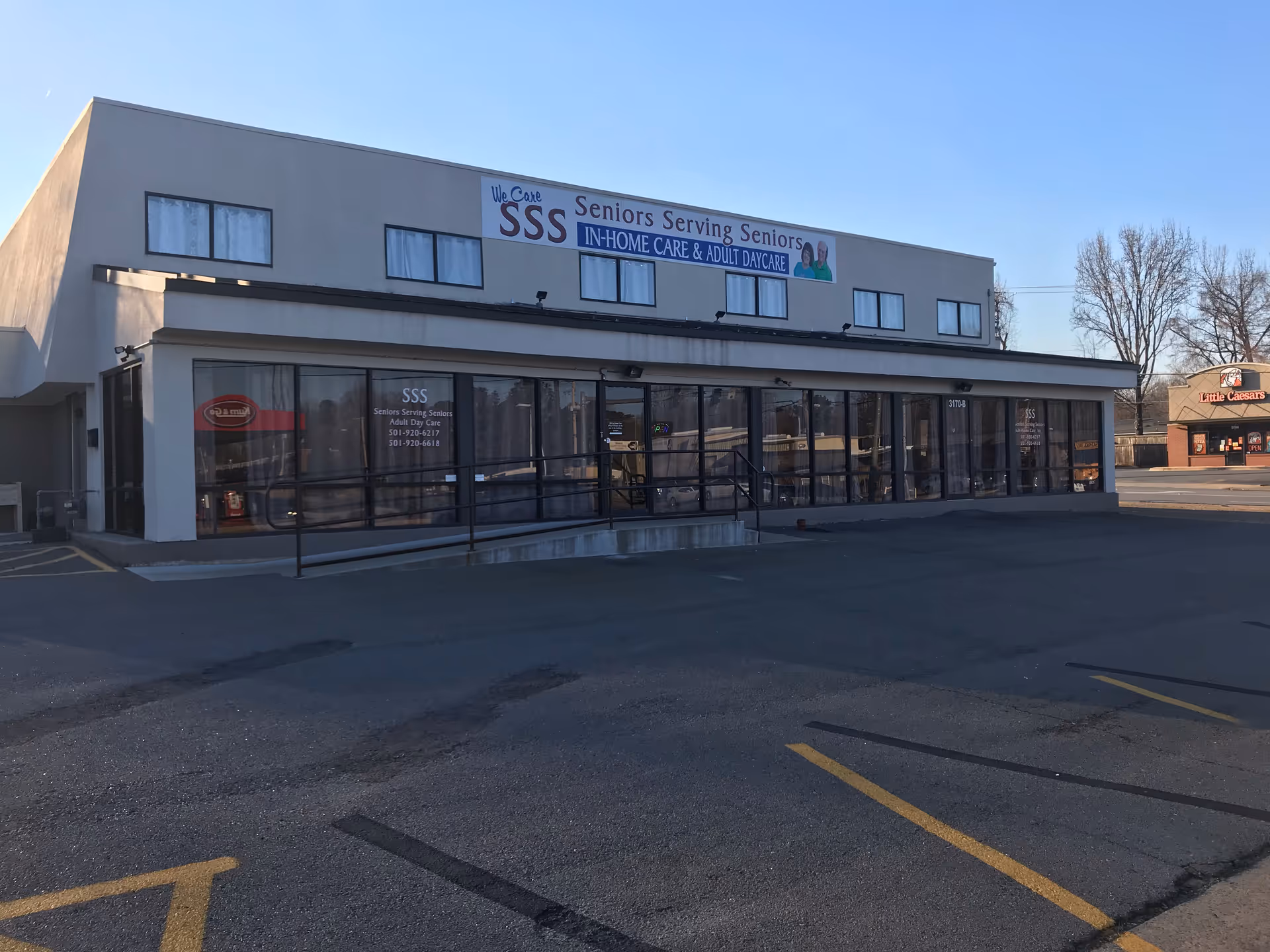 Exterior view of a senior care facility with signage reading Seniors Serving Seniors.