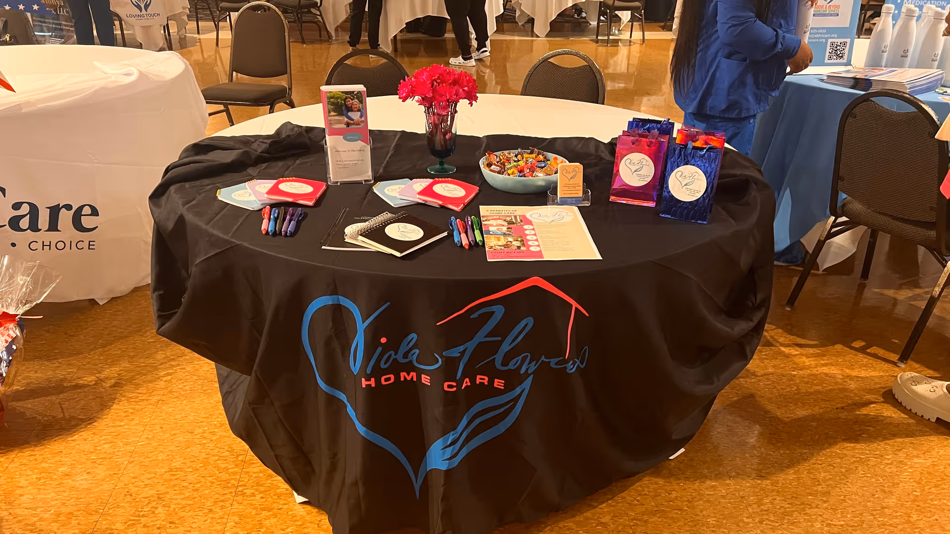 Indoor information table with Viola Flowers Home Care marketing materials.