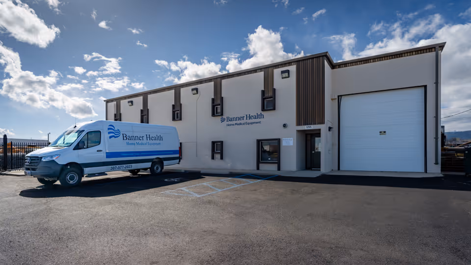 Exterior view of Banner Health Home Medical Equipment building with a branded van parked outside.