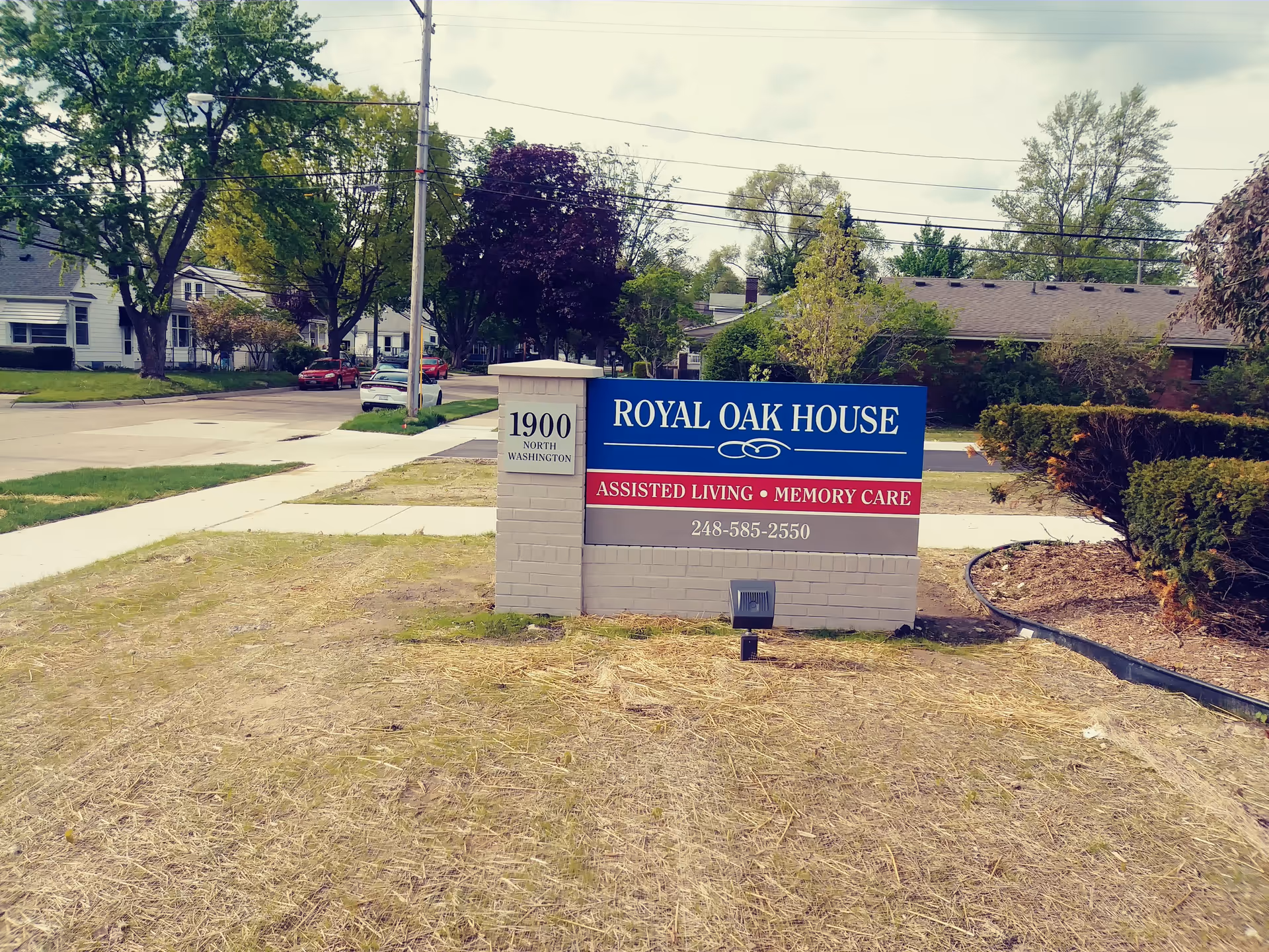 Exterior view of the Royal Oak House sign in a front yard.