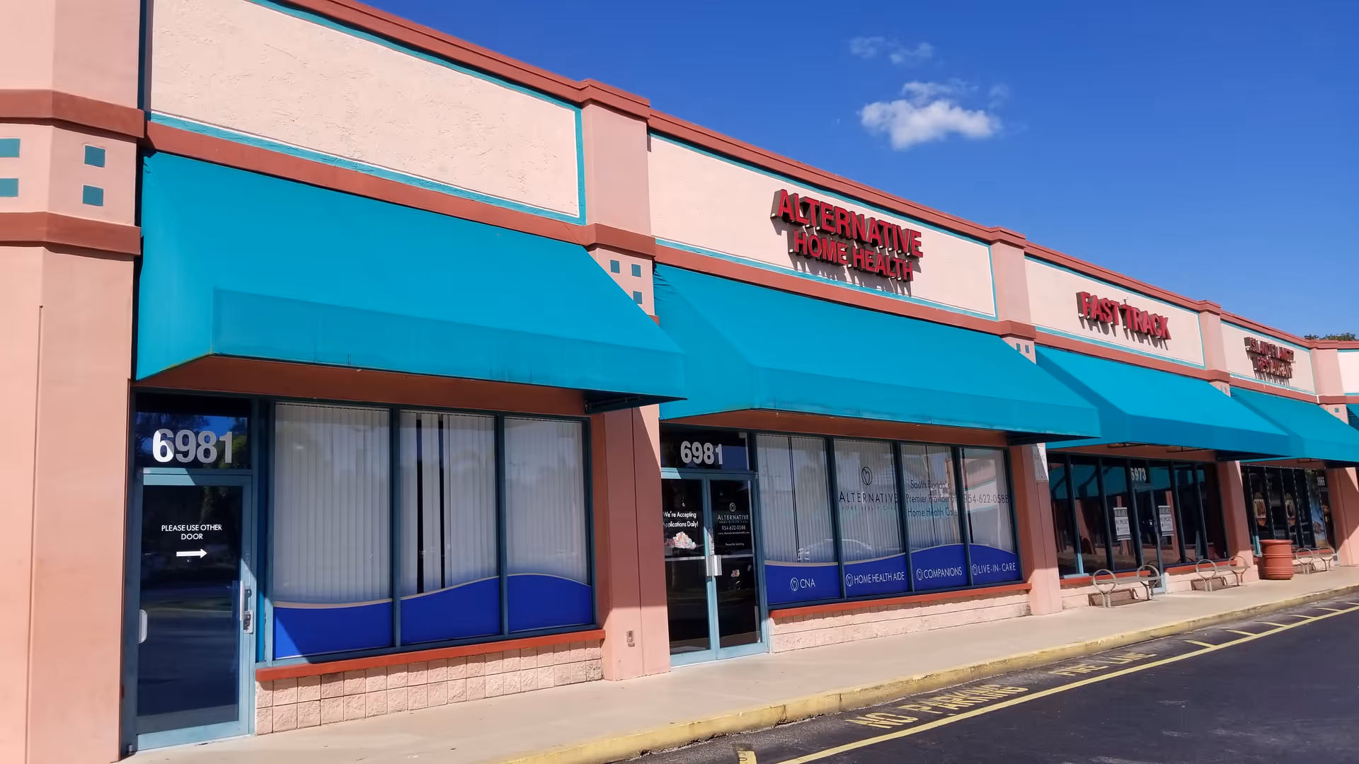 Exterior storefront with teal awnings and signage for Alternative Home Healthcare of Broward County.