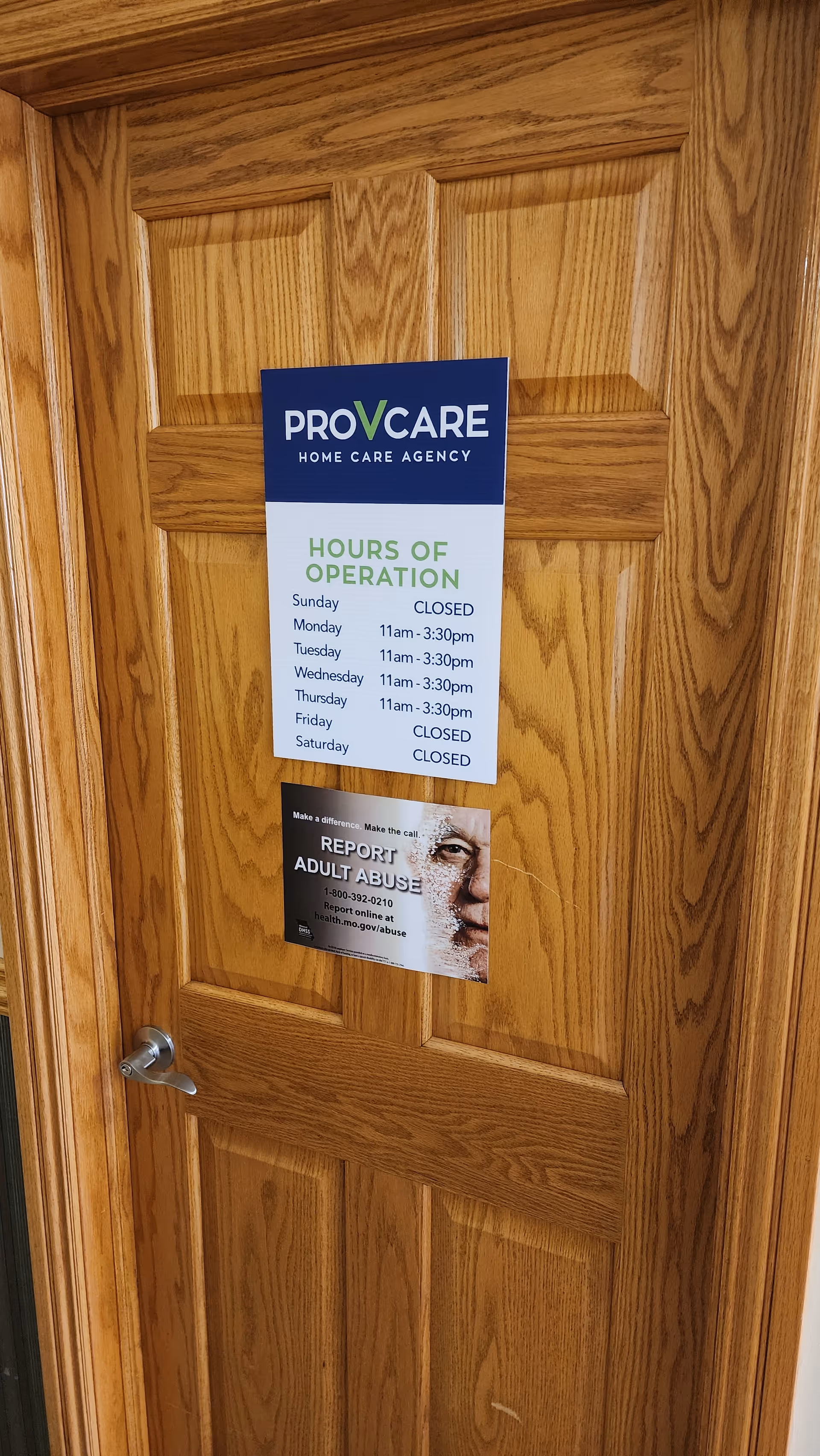 Wooden interior door with PROVCARE Home Care Agency signs and an abuse report poster.