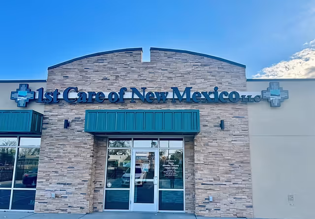 Exterior view of a stone-clad building entrance with the 1st Care of New Mexico LLC sign.