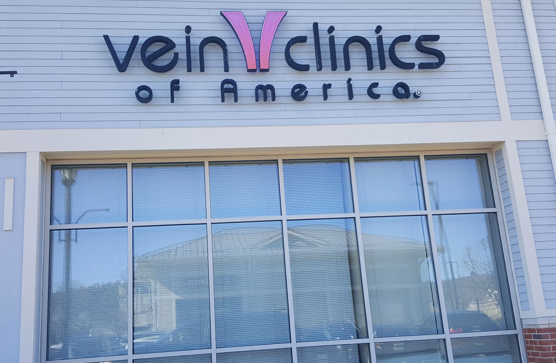 Exterior storefront of USA Vein Clinics with large glass windows and sign.