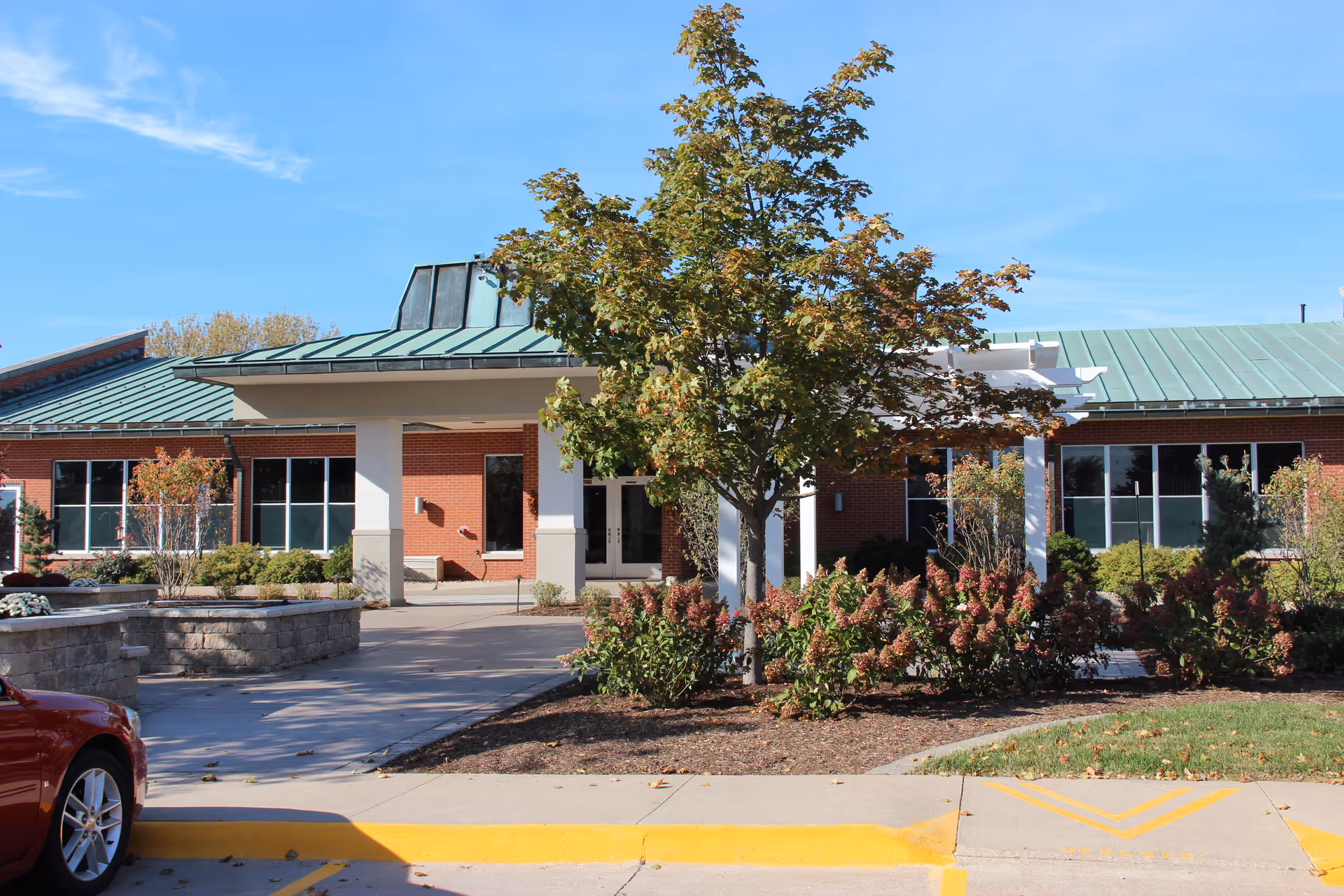Exterior view of The Alverno Senior Care Community building with landscaping and parking.