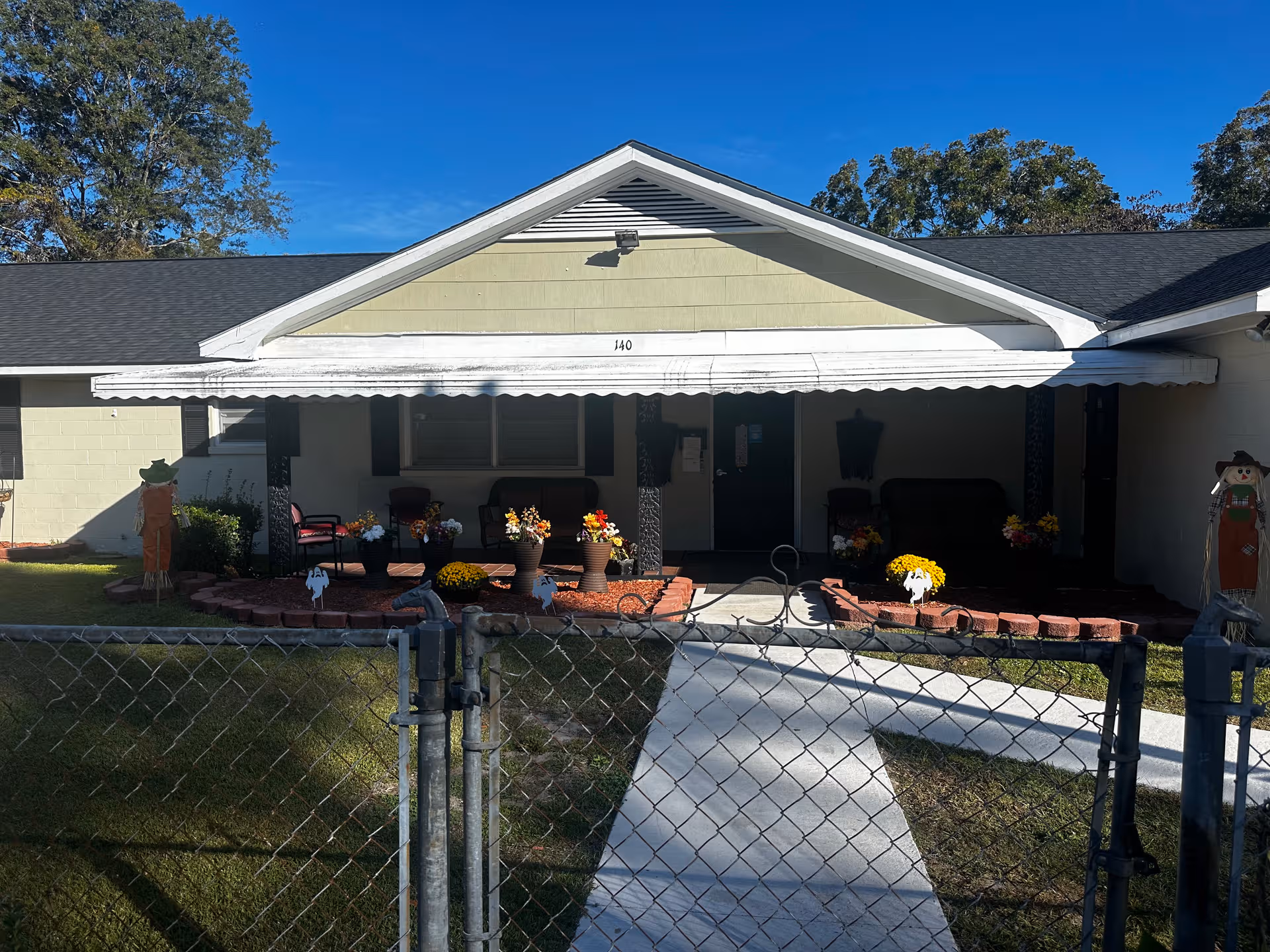 Front view of Legacy Memory Care at Kinston with a covered porch and seating.