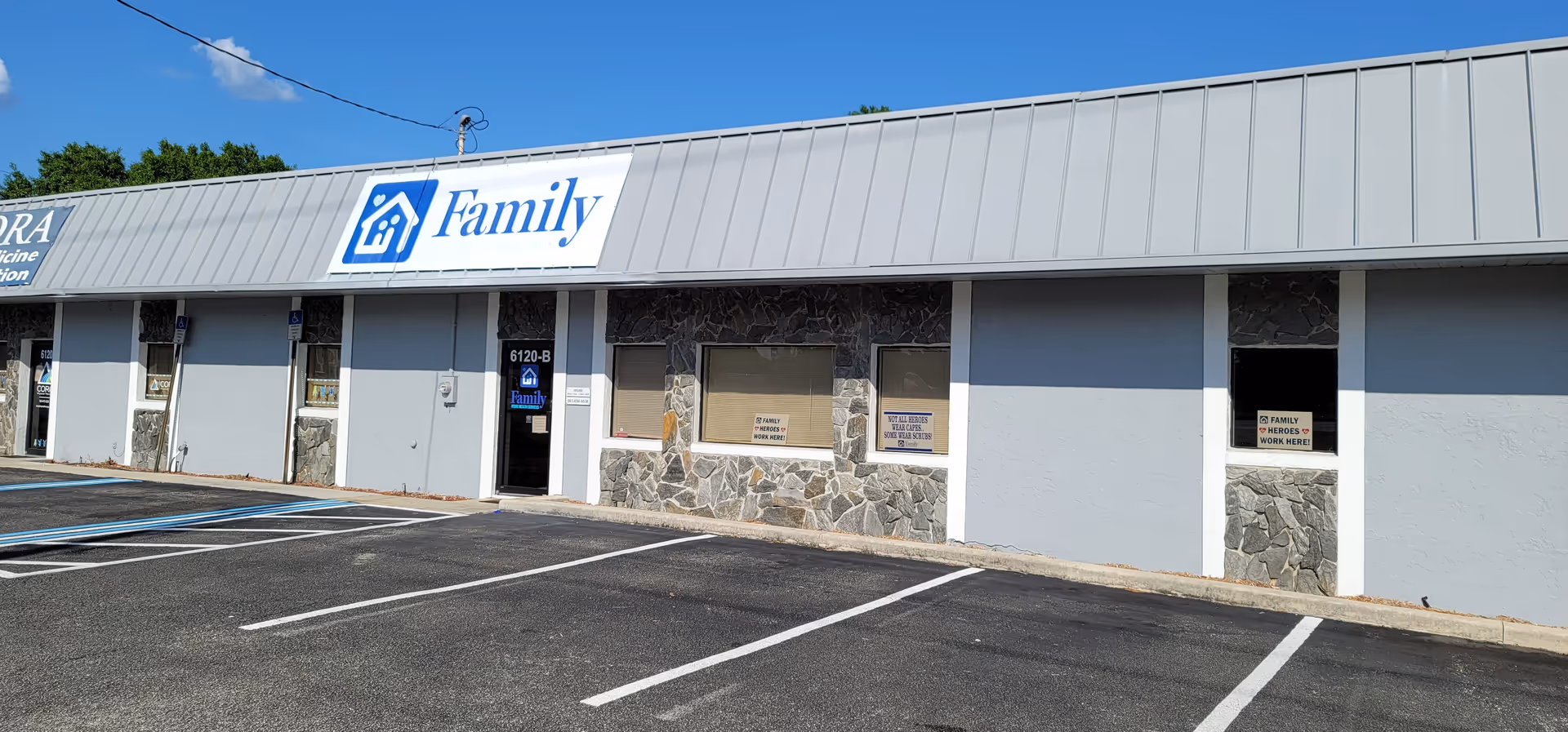 Front exterior of a single-story storefront with a large Family sign and empty parking lot.