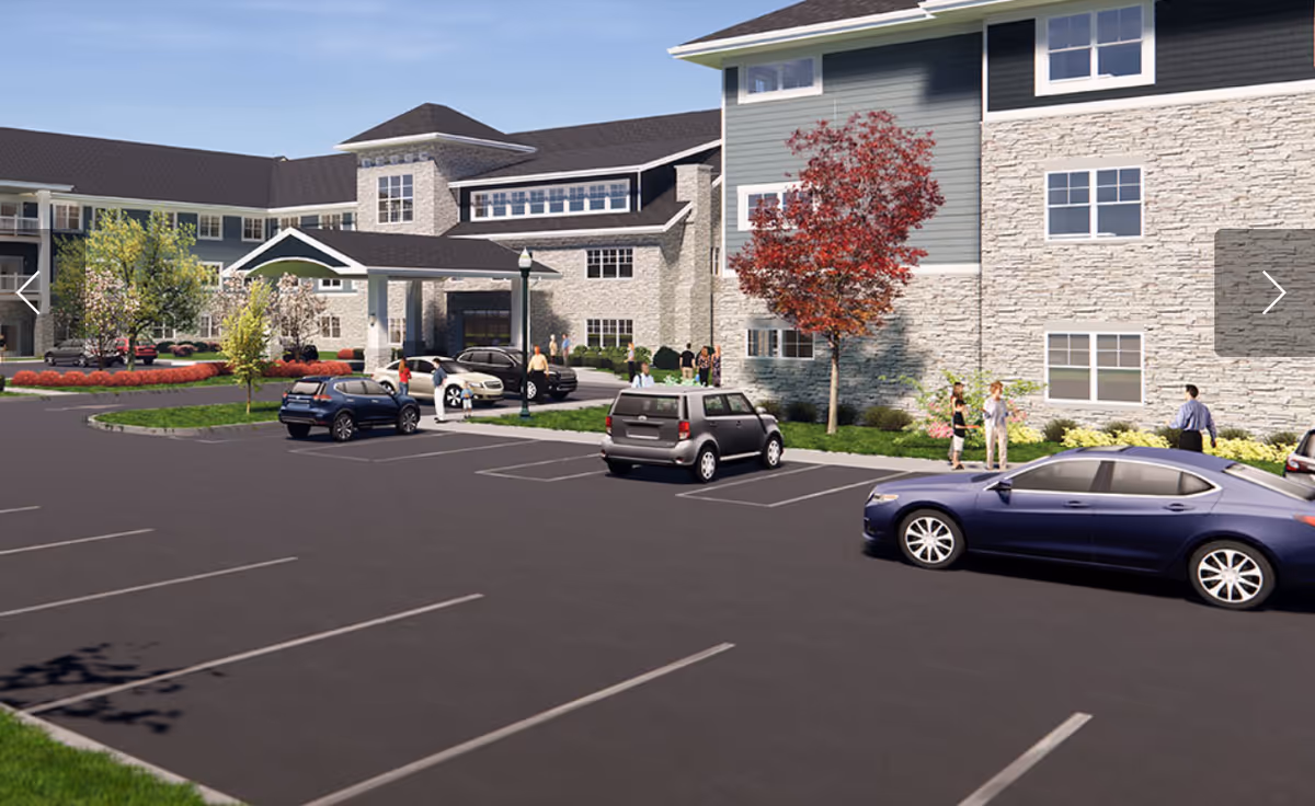 Exterior view of Clarendale Of St. Peters with parked cars and residents near the entrance.