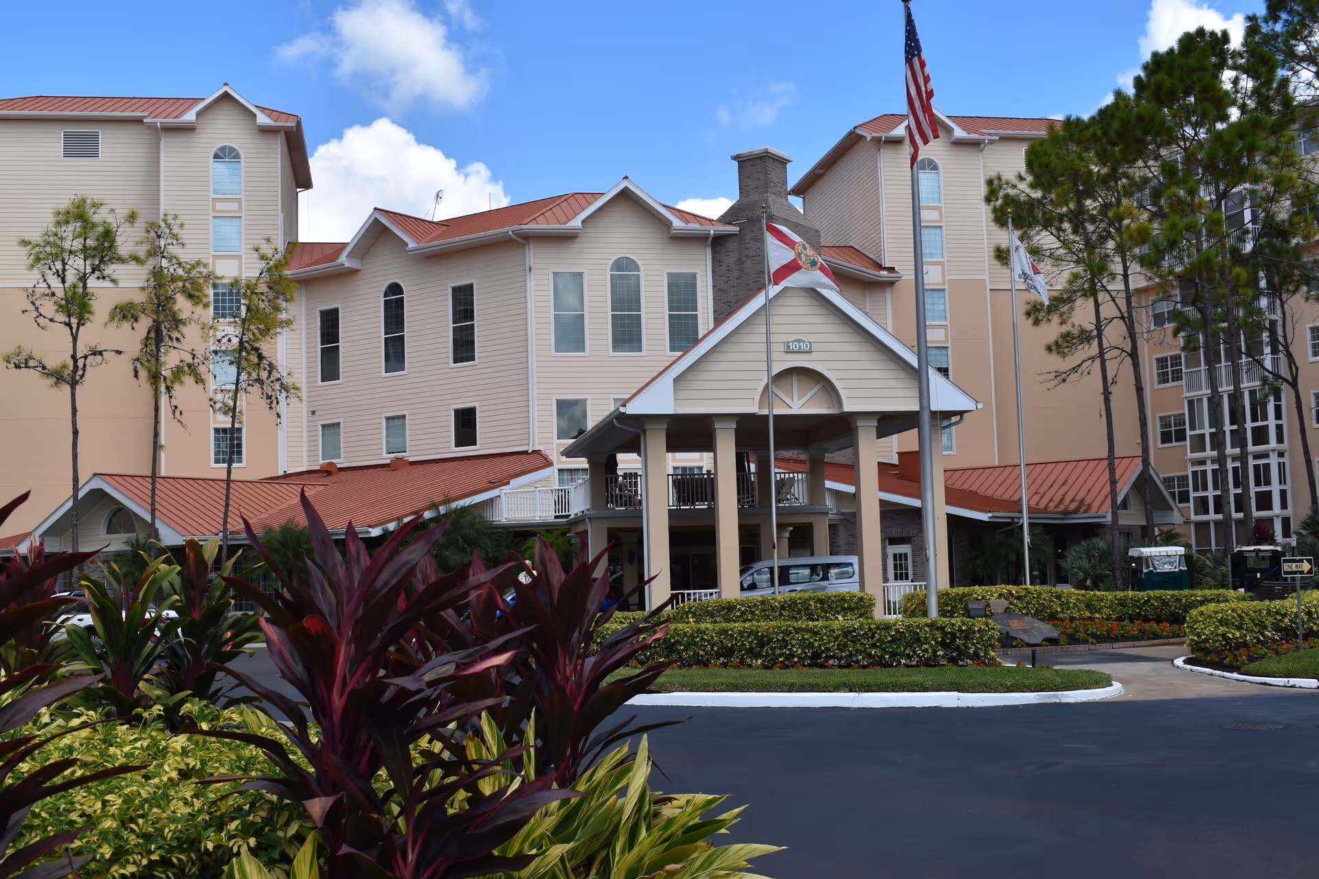 Front exterior view of Homewood at Sun City Center residential building with entrance canopy and landscaping.