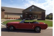 Red convertible parked in front of Bethany Home Sioux Falls facility entrance.