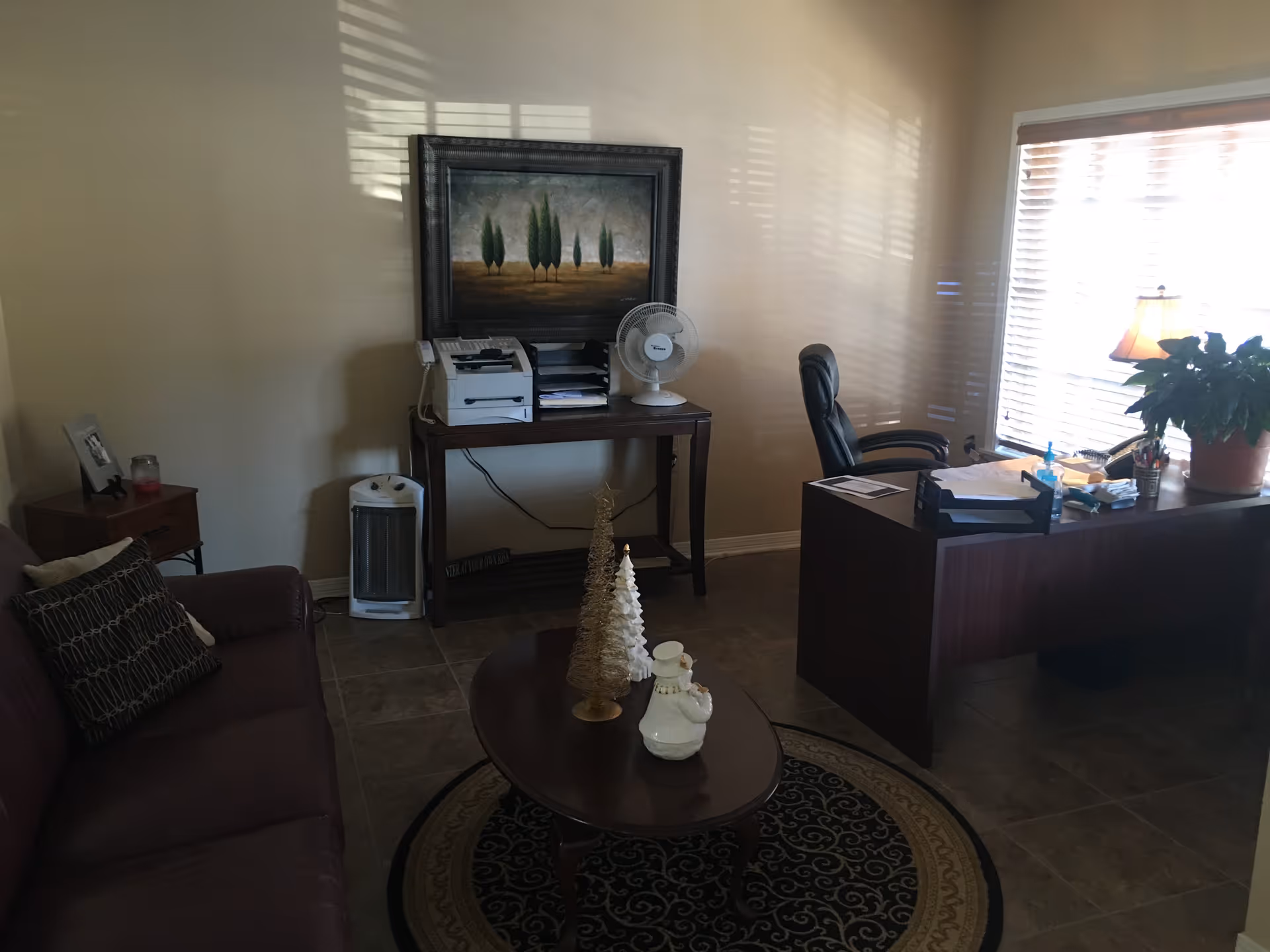 Interior office area with desk, chair, printer, and holiday decor.