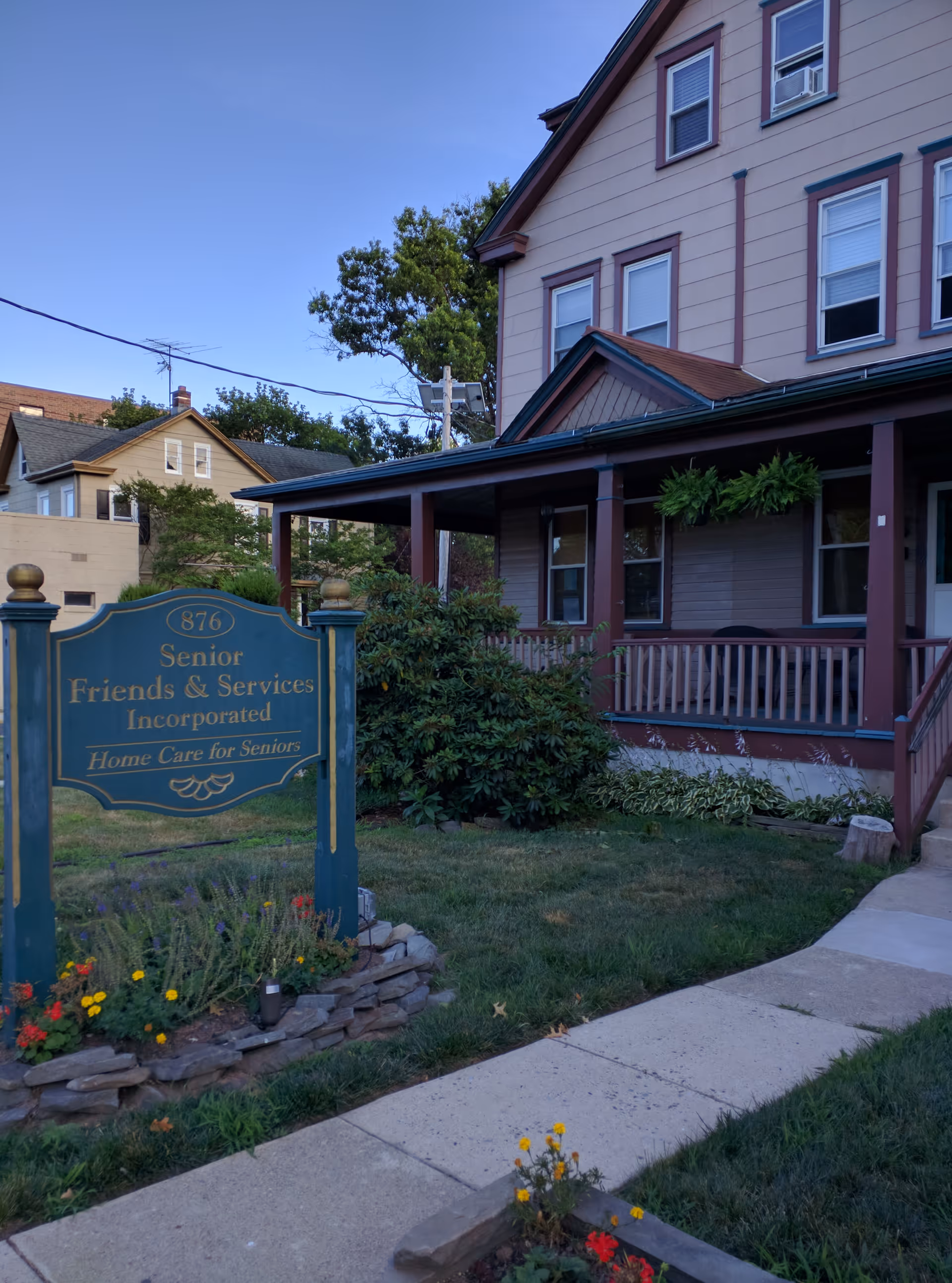 Exterior view of Senior Friends & Services Inc. facility with sign and front porch.
