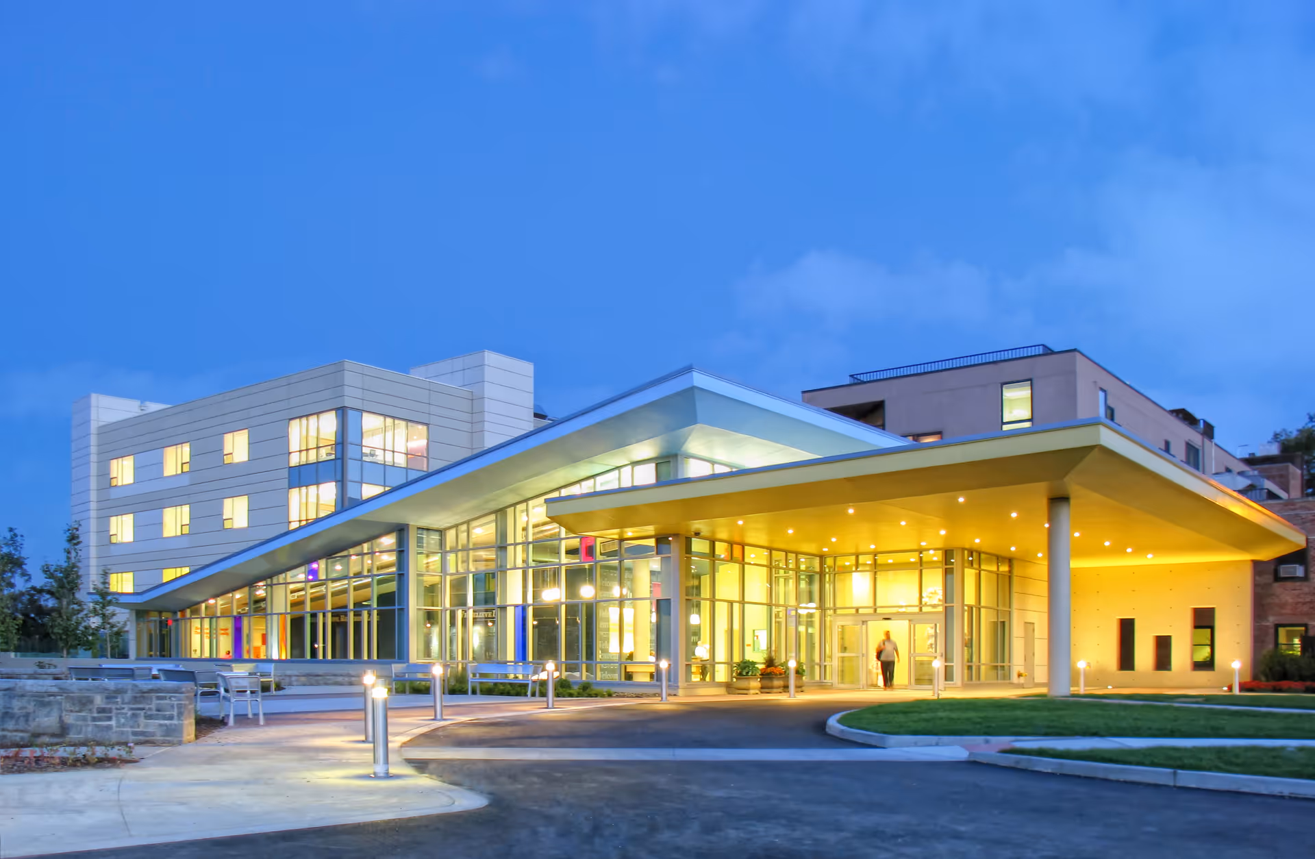 St. Mary's Hospital For Children exterior entrance with glass walls and warm canopy lighting.