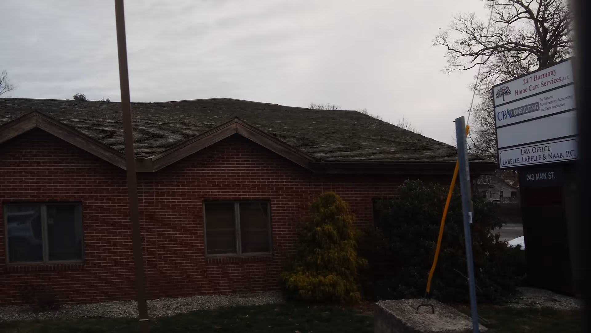Brick single-story exterior with a sign for 24/7 Harmony Home Care Services, LLC.