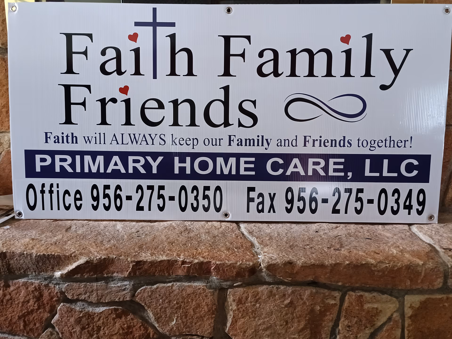 Outdoor sign for Faith Family Friends PHC, Primary Home Care, with contact numbers.