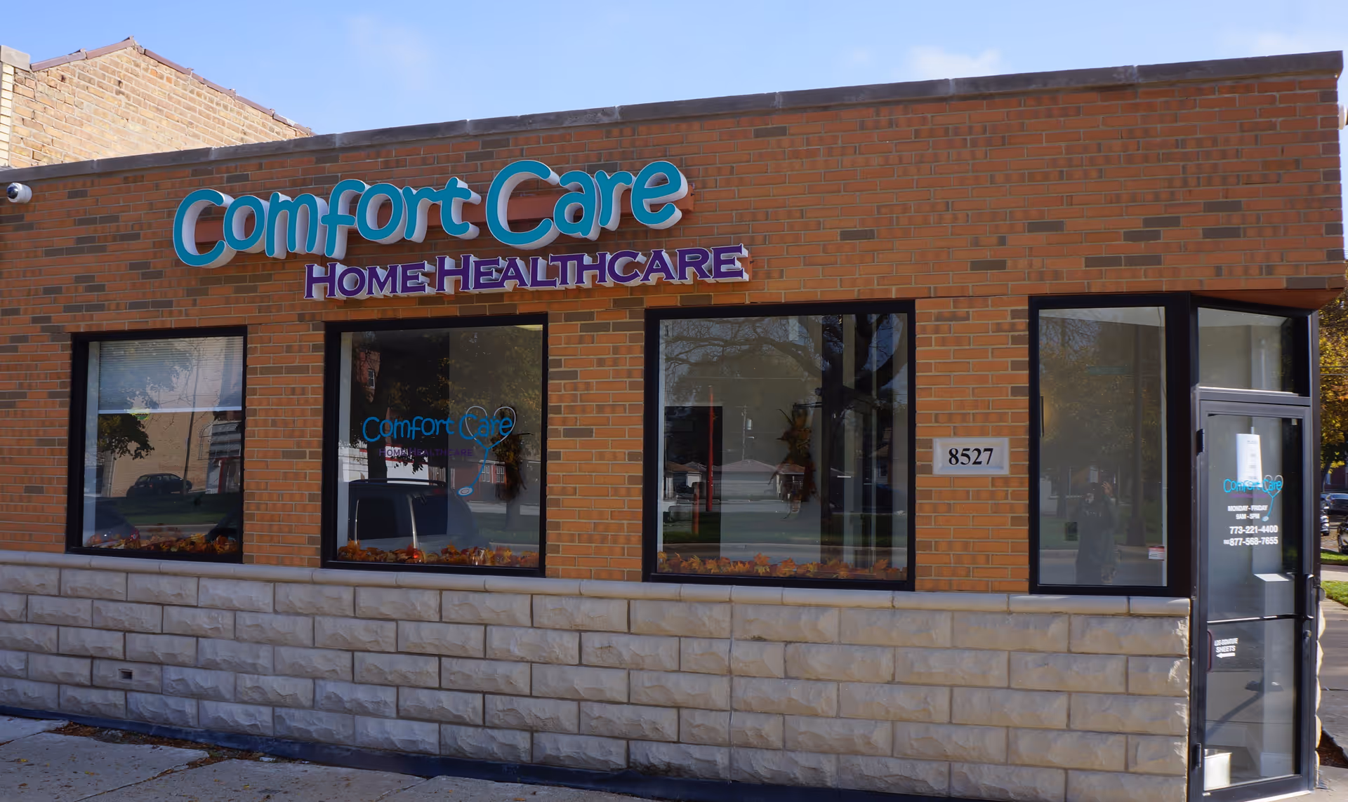 Brick building exterior with large Comfort Care Home Healthcare sign above three front windows.