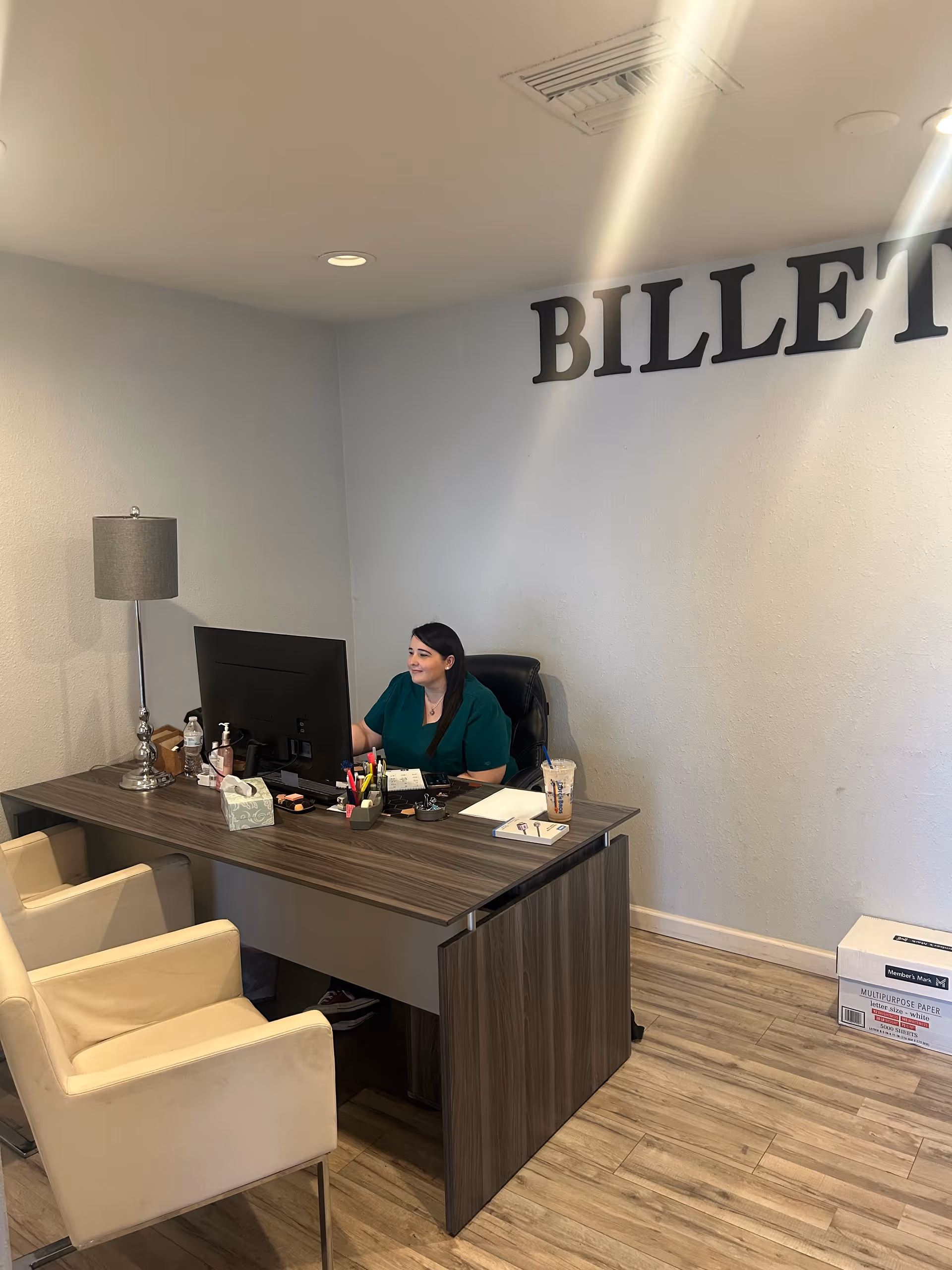 Reception desk inside Billet Home Health Bullhead City with a staff member at a computer.
