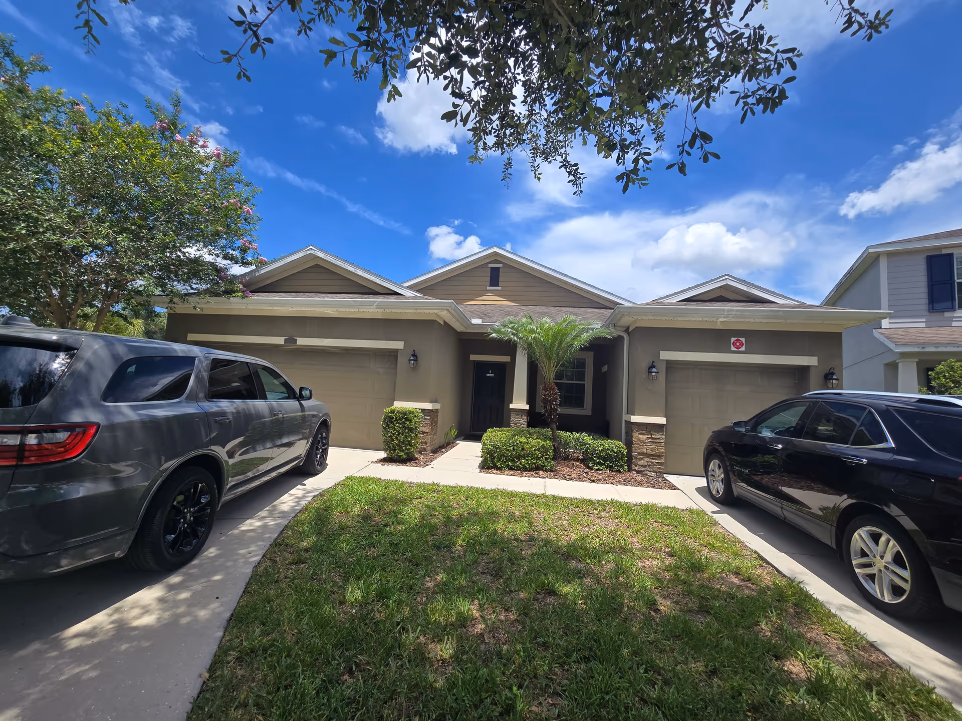 Front exterior of Blessing Angels Assisted Living LLC, a single-story building with two garages and cars.