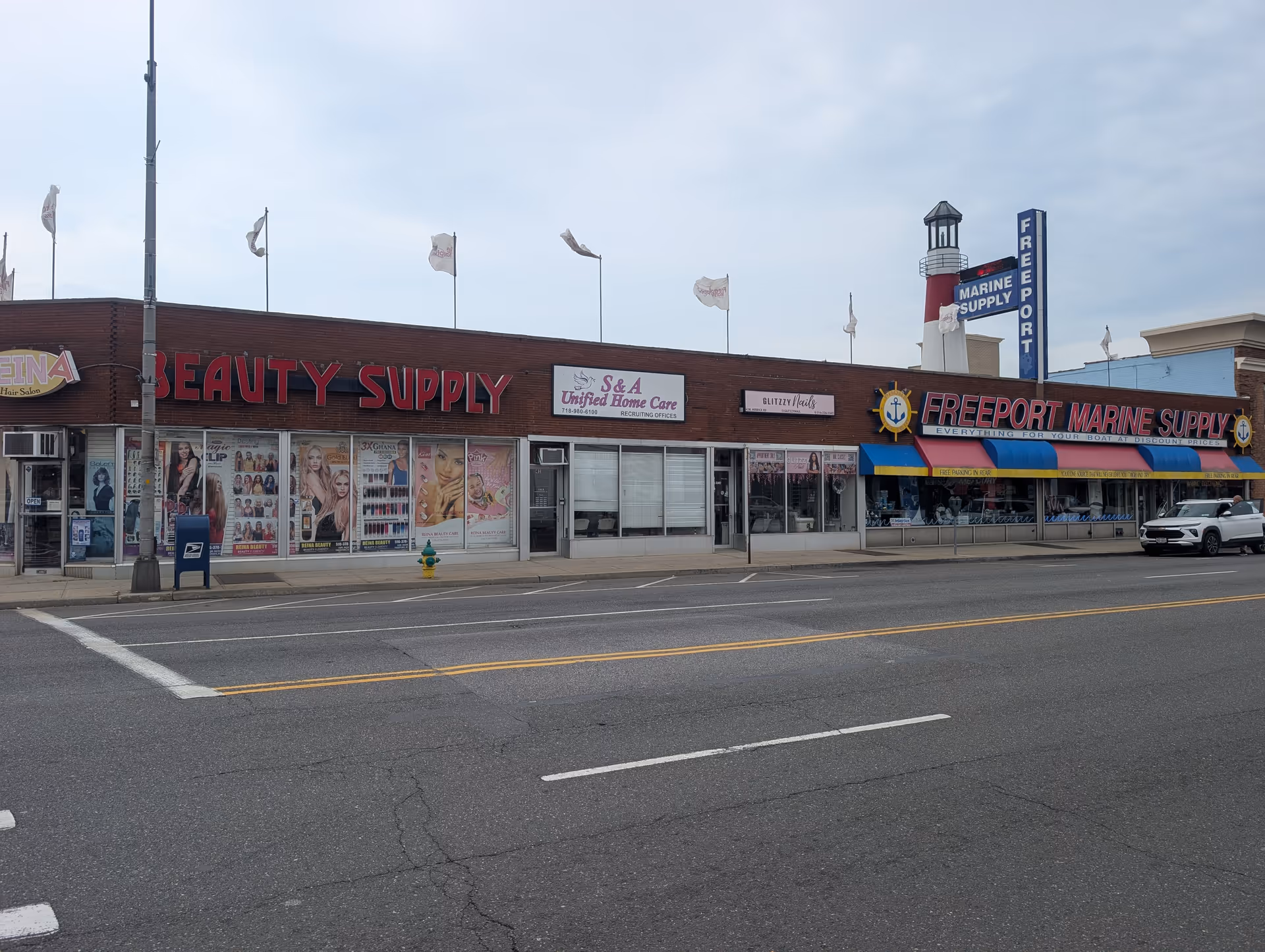 Row of storefronts along a street, including S and A Unified Home Care sign.