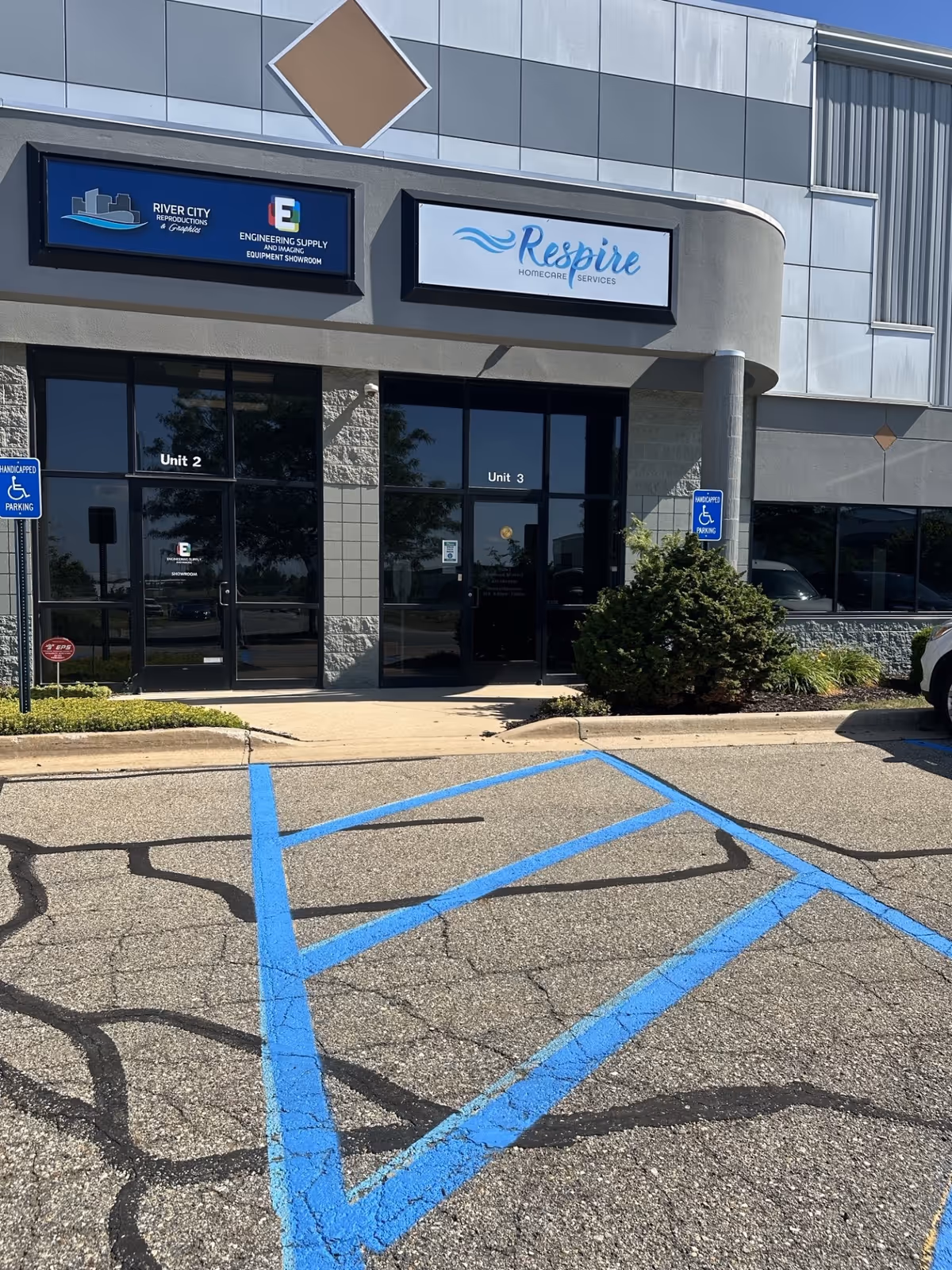 Exterior view of Respire Homecare Services building with parking lot and blue handicap markings.