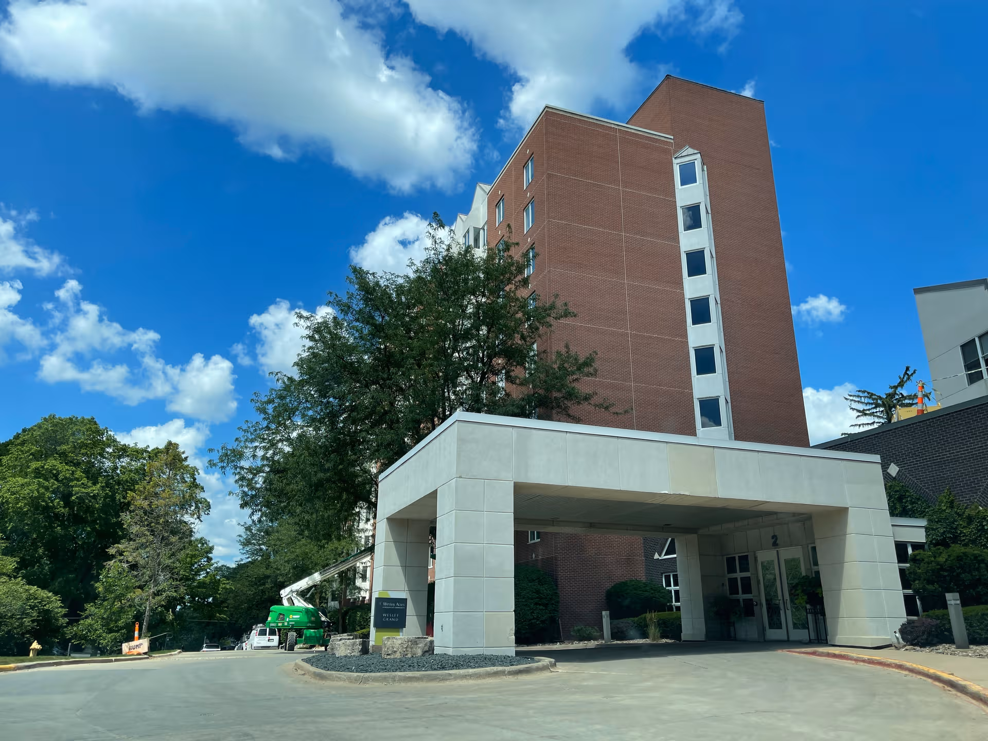 Wesley on Grand exterior: tall brick building with a covered entrance.