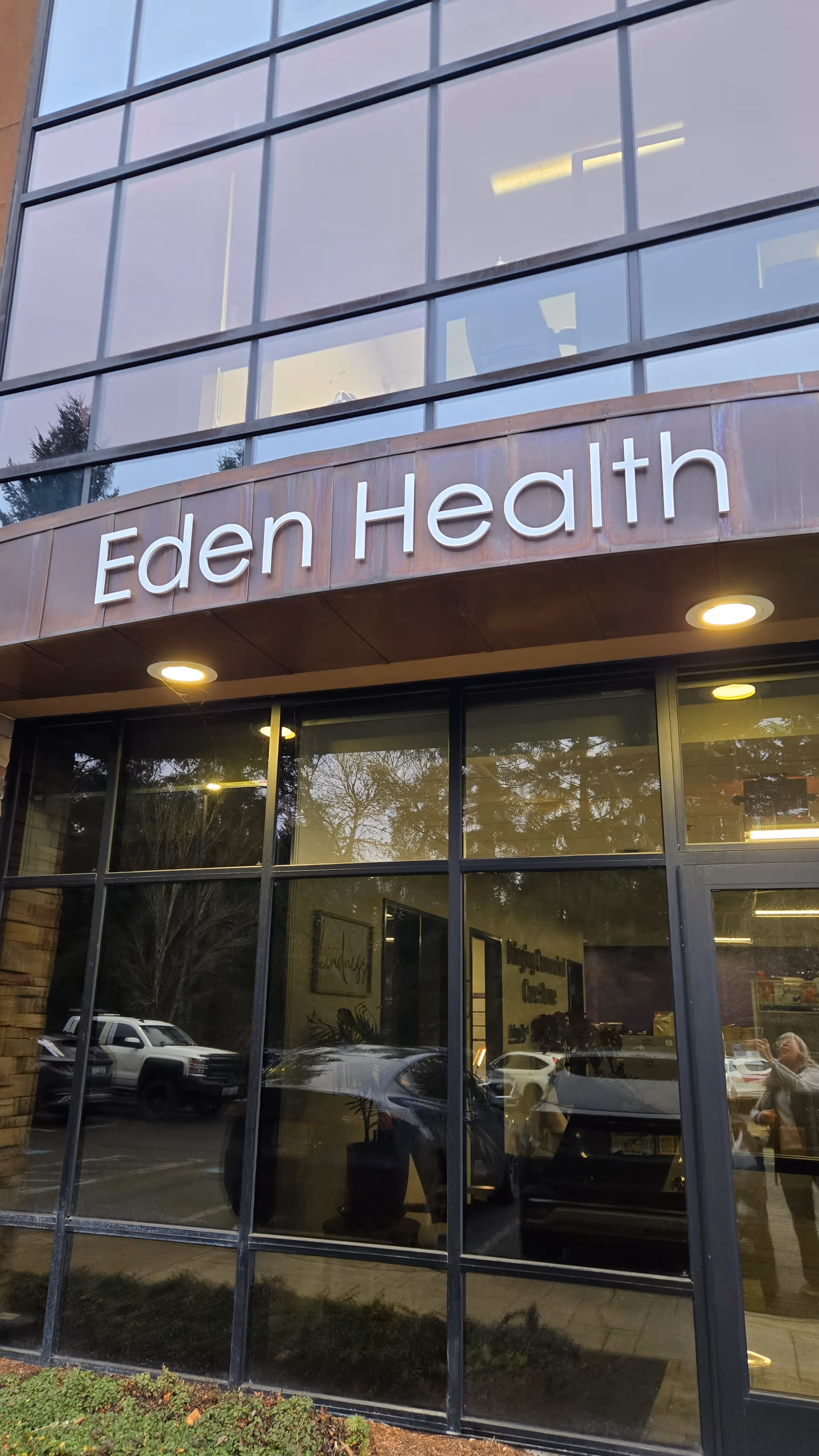 Exterior view of Eden Health building with large glass windows and signage.