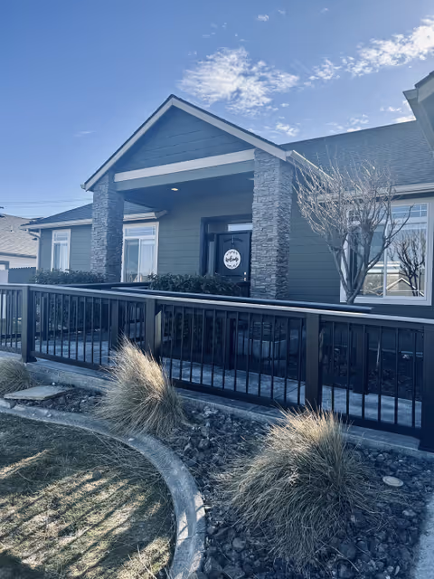 Front exterior of Sunset Heights Adult Family Home with a covered porch and railing.