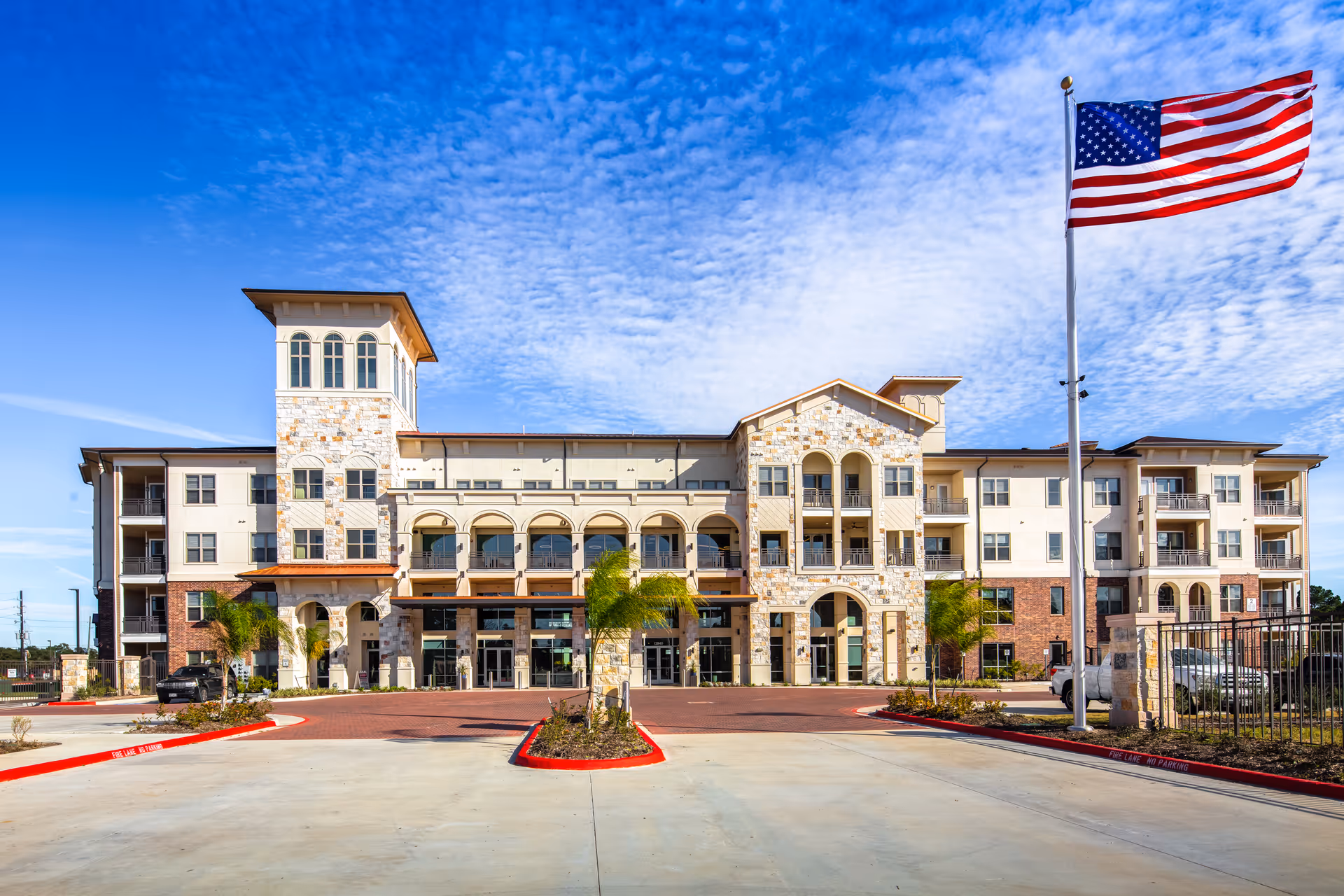 Front exterior view of Arella on Jones Active Senior Community building with flag