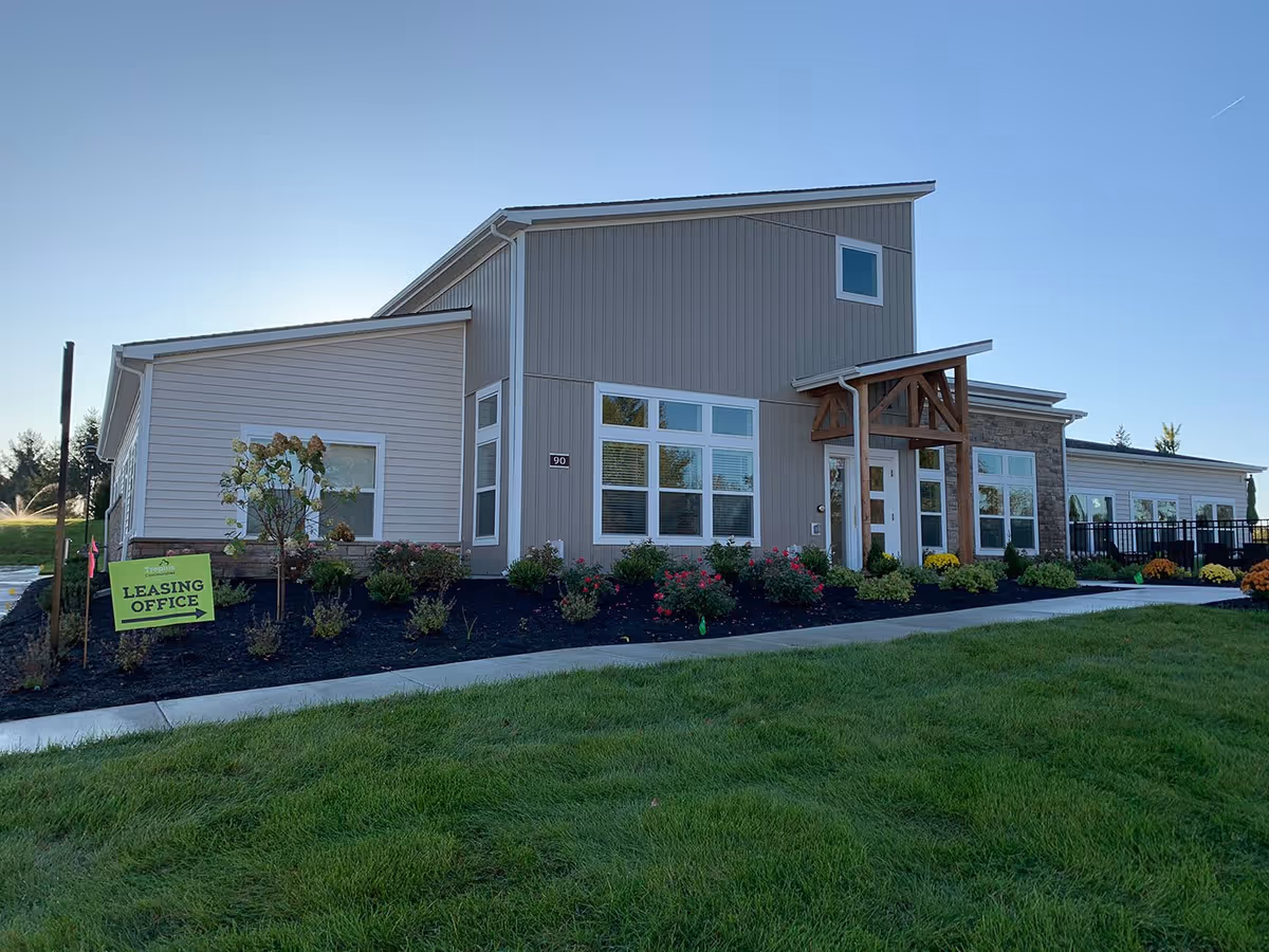 Exterior view of Burr Oak Commons senior living facility with a leasing office sign.