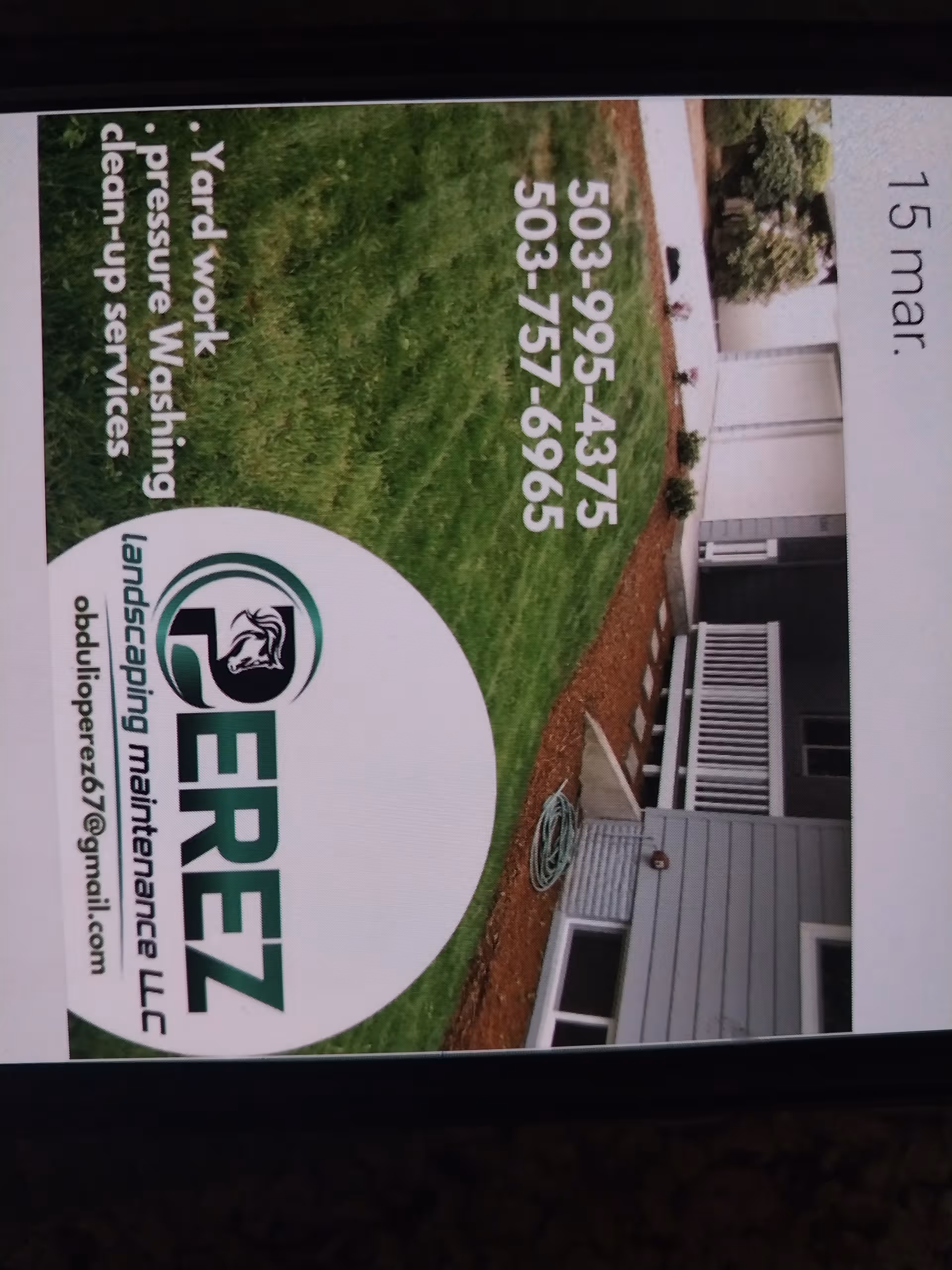 Exterior of a house with a large circular lawn-care sign on the lawn