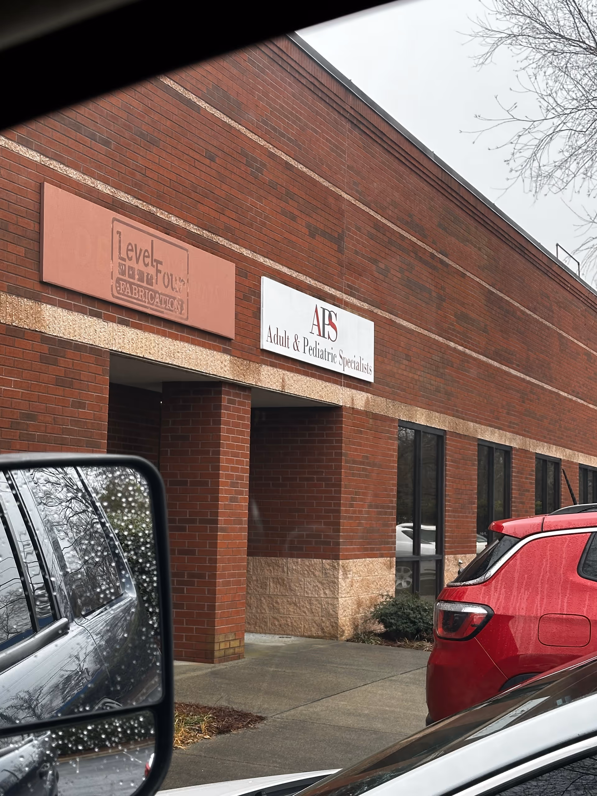 Brick exterior of a medical office building with AIS Adult and Pediatric Specialists signage.