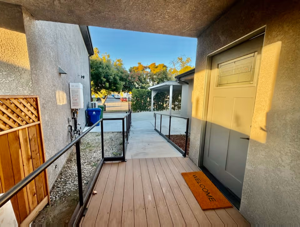 Exterior entry at Eternal Life Assisted Living with ramp, railing, and welcome mat.