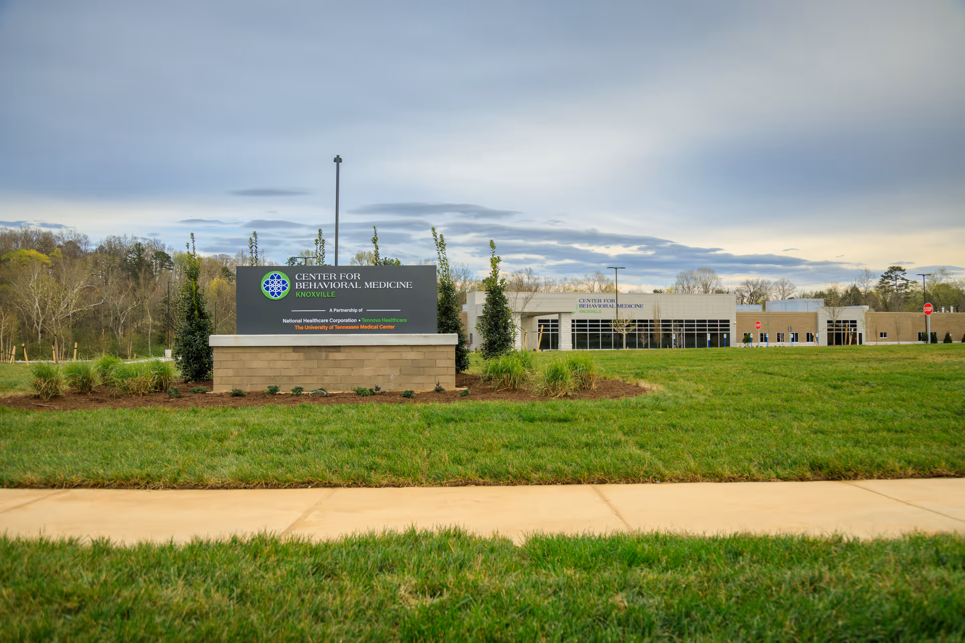 Exterior view of Knoxville Center for Behavioral Medicine with sign and entrance across a grassy lawn