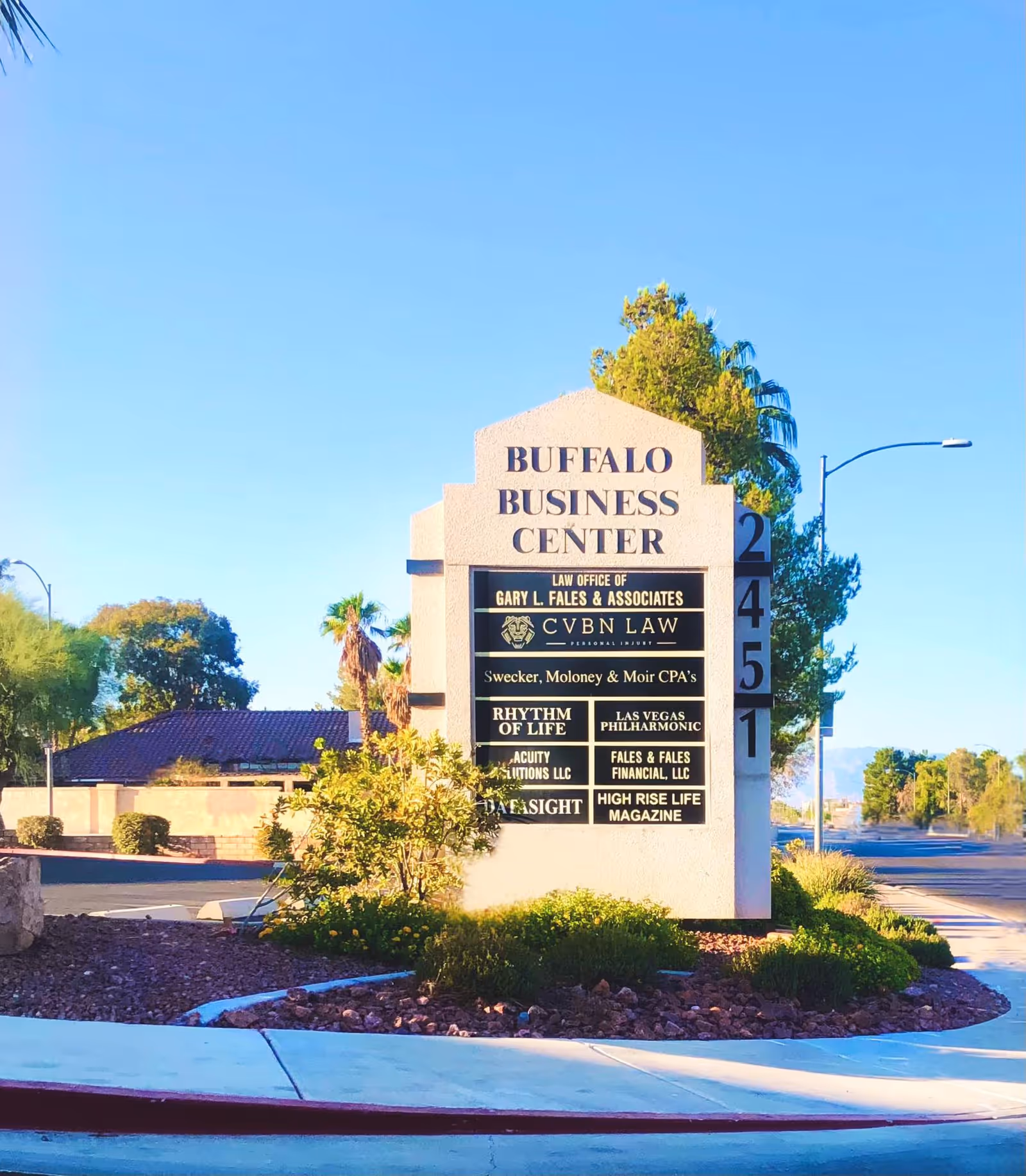 Outdoor sign for Buffalo Business Center listing Rhythm of Life Hospice Care among tenants.