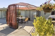 Outdoor patio at Windsor Care Center of Petaluma with brown canopy and seating.