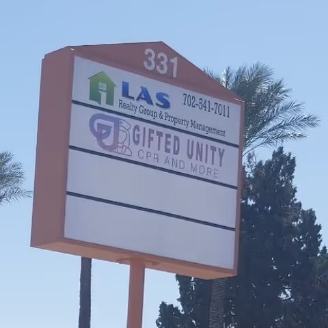 Outdoor signboard with Gifted Unity CPR and More branding and palm trees nearby.